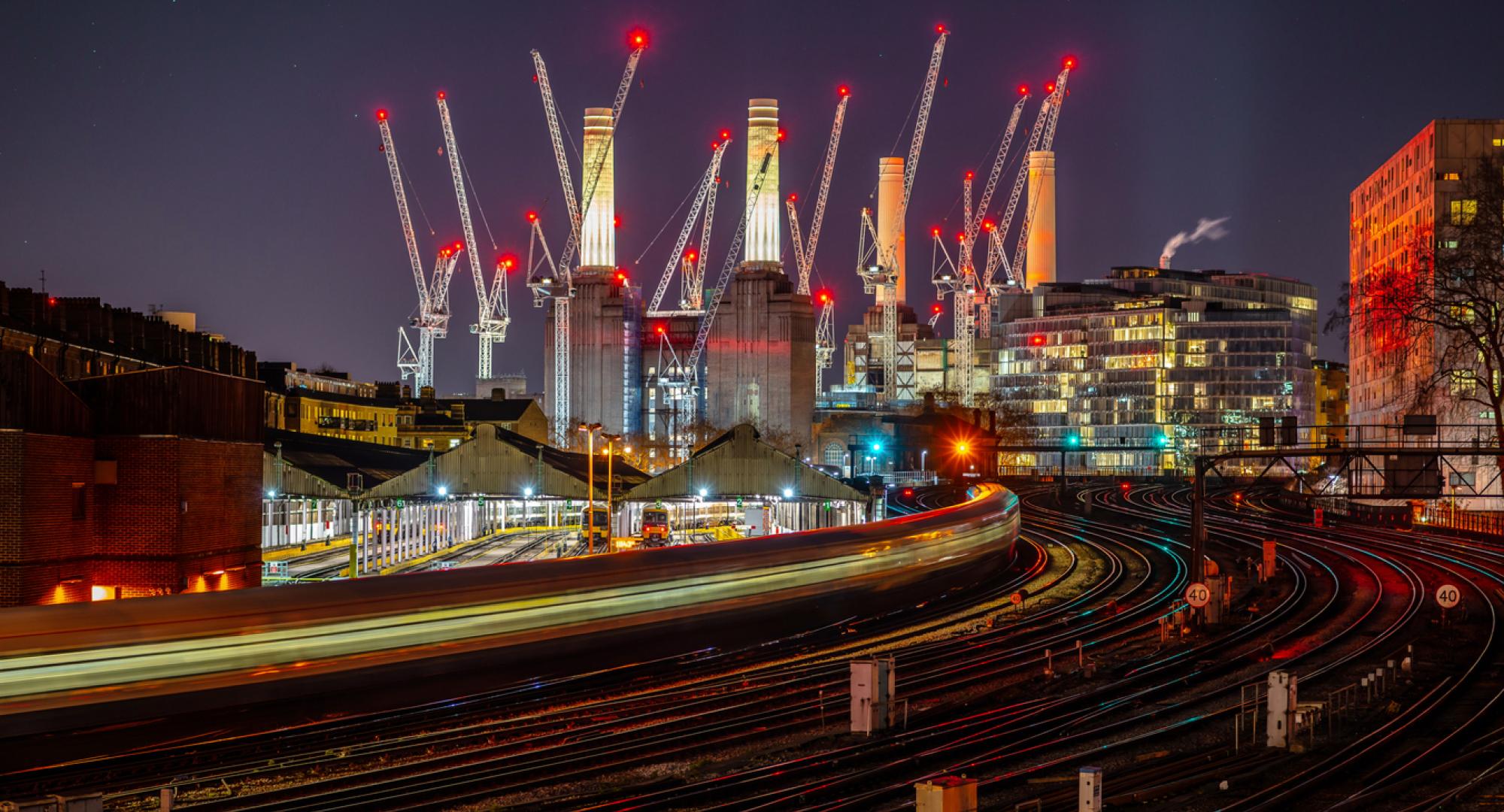 Battersea power station and rail links at night