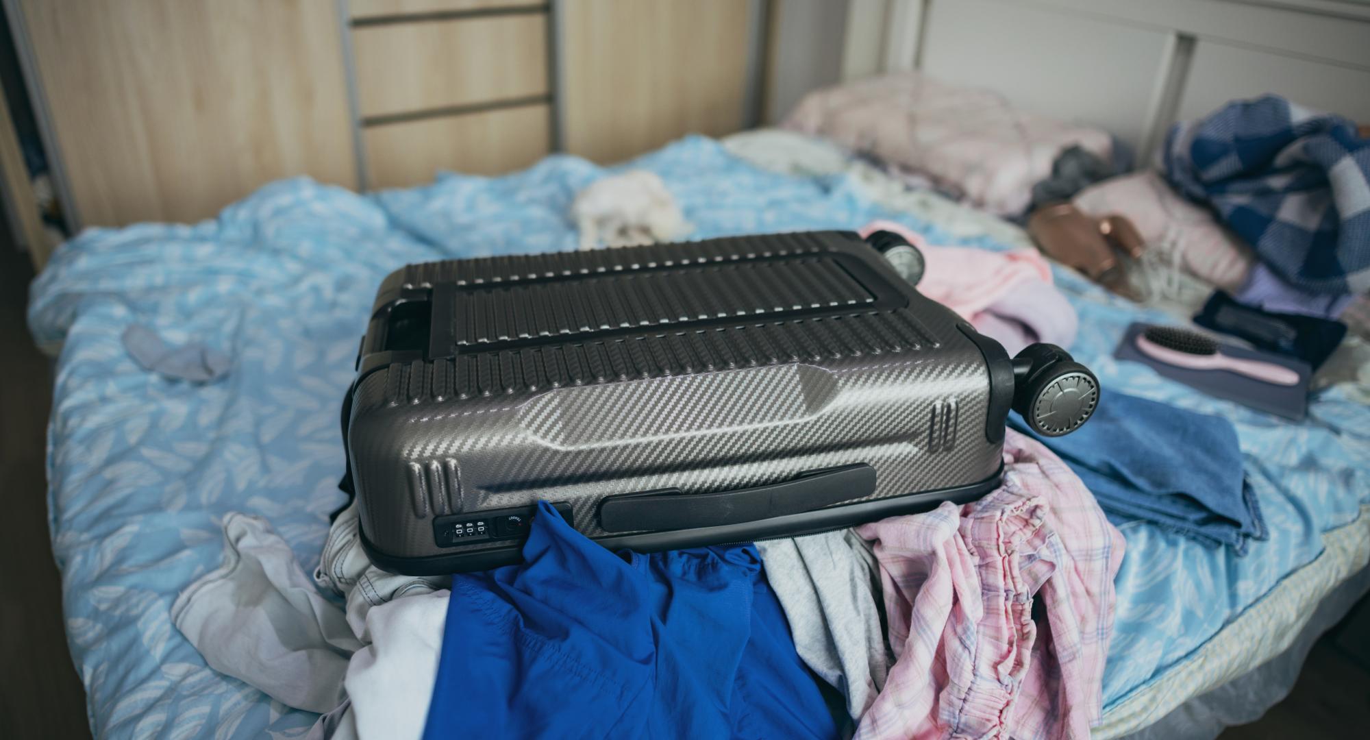 Suitcase on a bed of a temporary accomodation