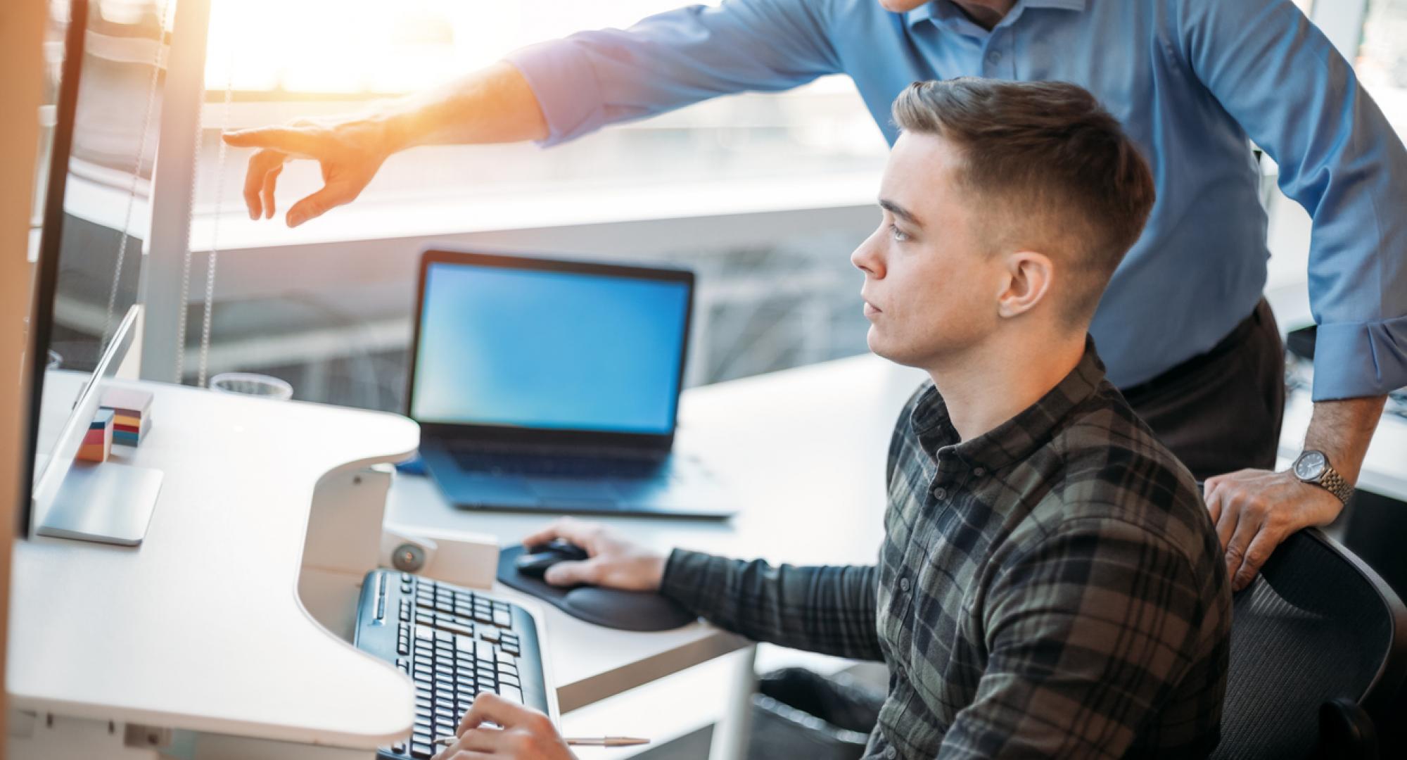 Young man on work experience at a computer