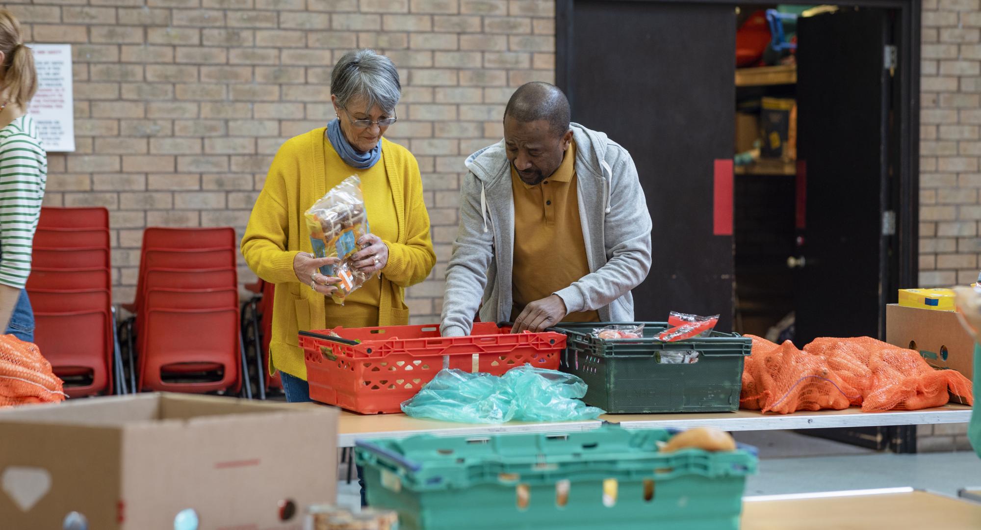 Woman and a man setting up a food bank in the North of England