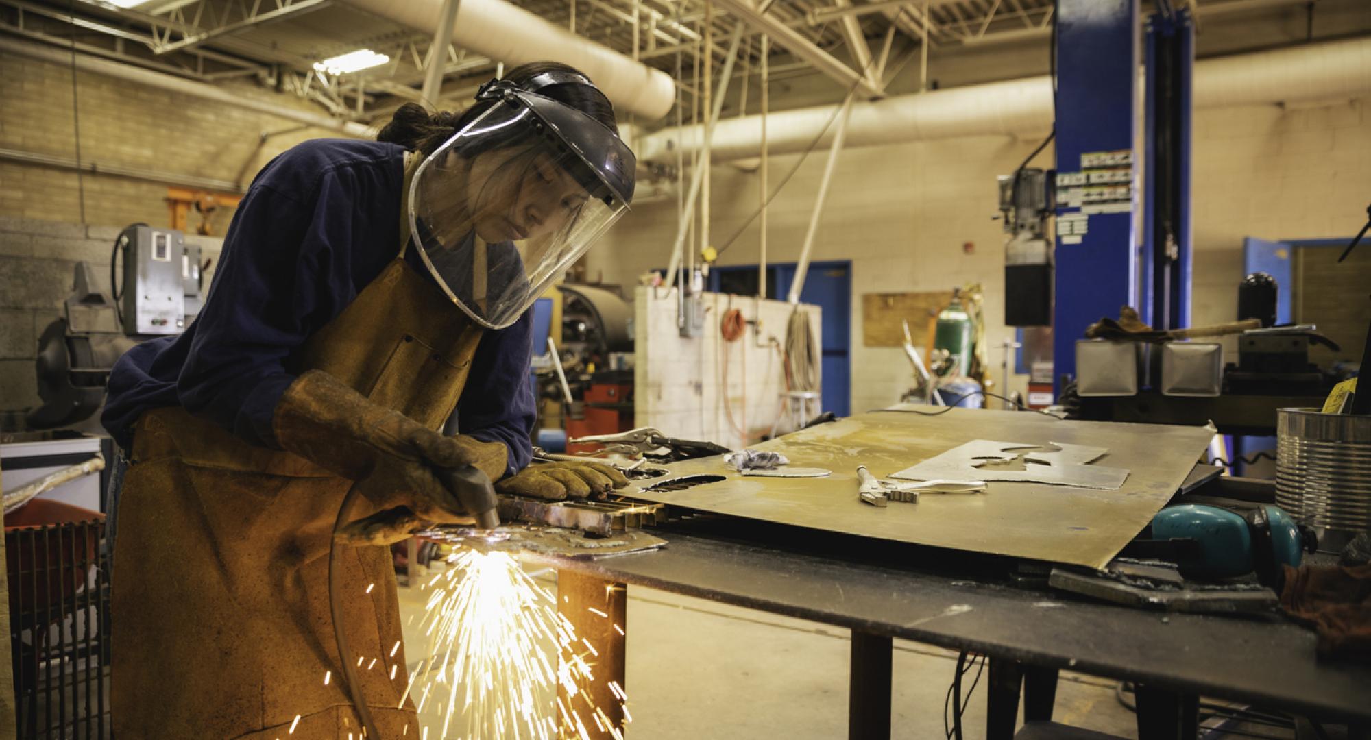 Young woman welding