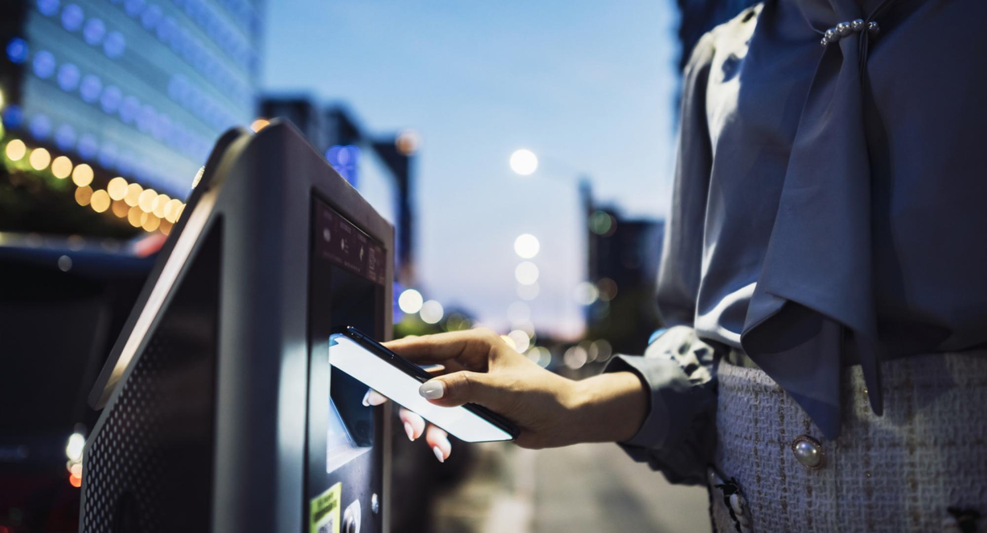 Woman paying for parking on her phone