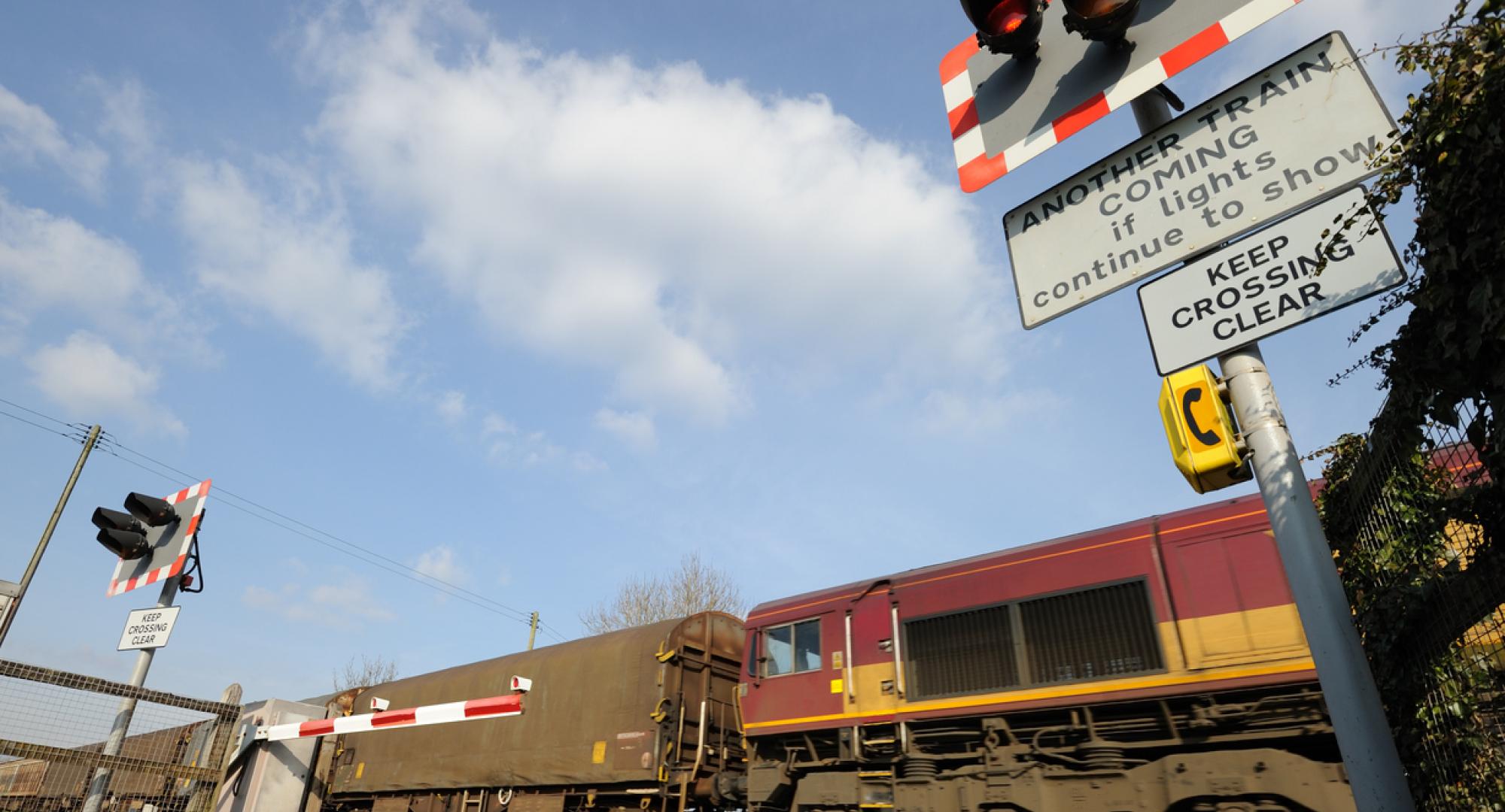 Freight train going through a level crossing