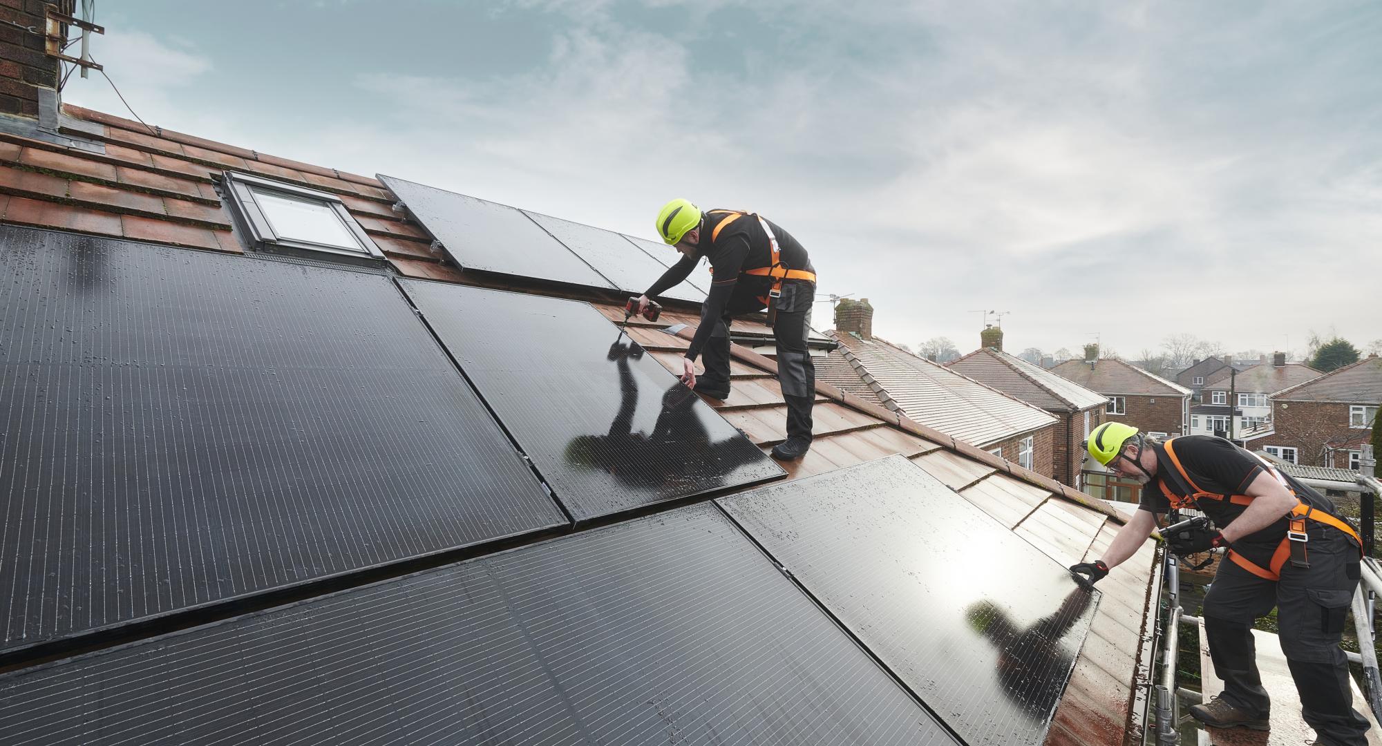 Men installing solar panels, a source of green energy