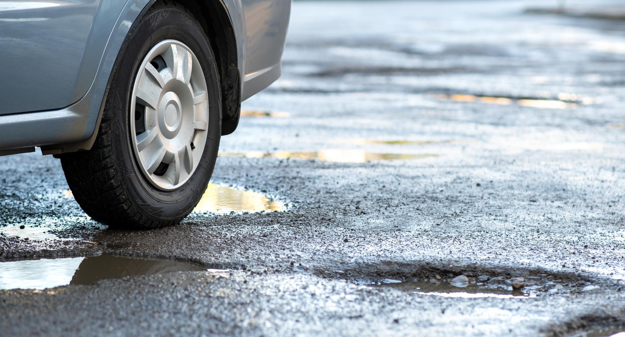 Pothole with a car about to drive over