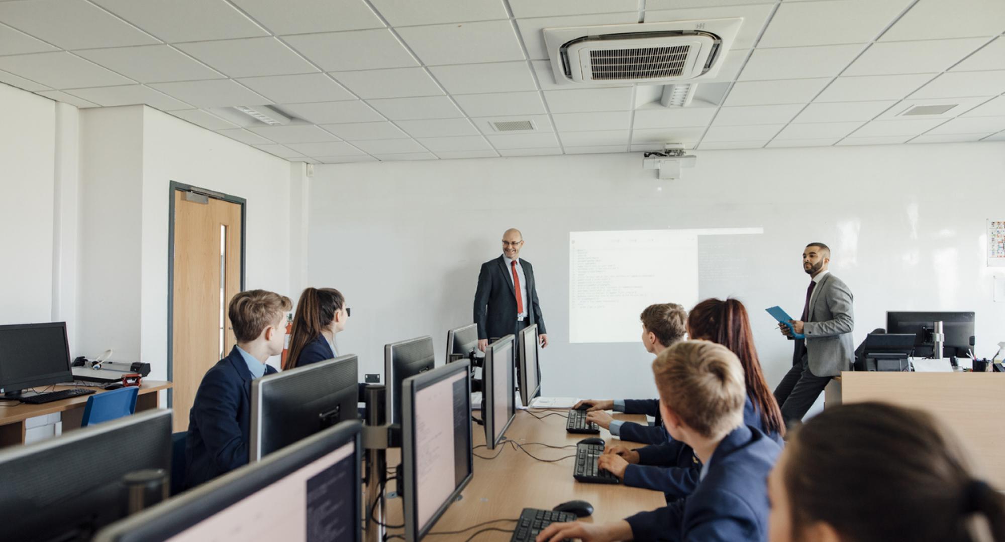 Pupils sat working on computers in a classroom