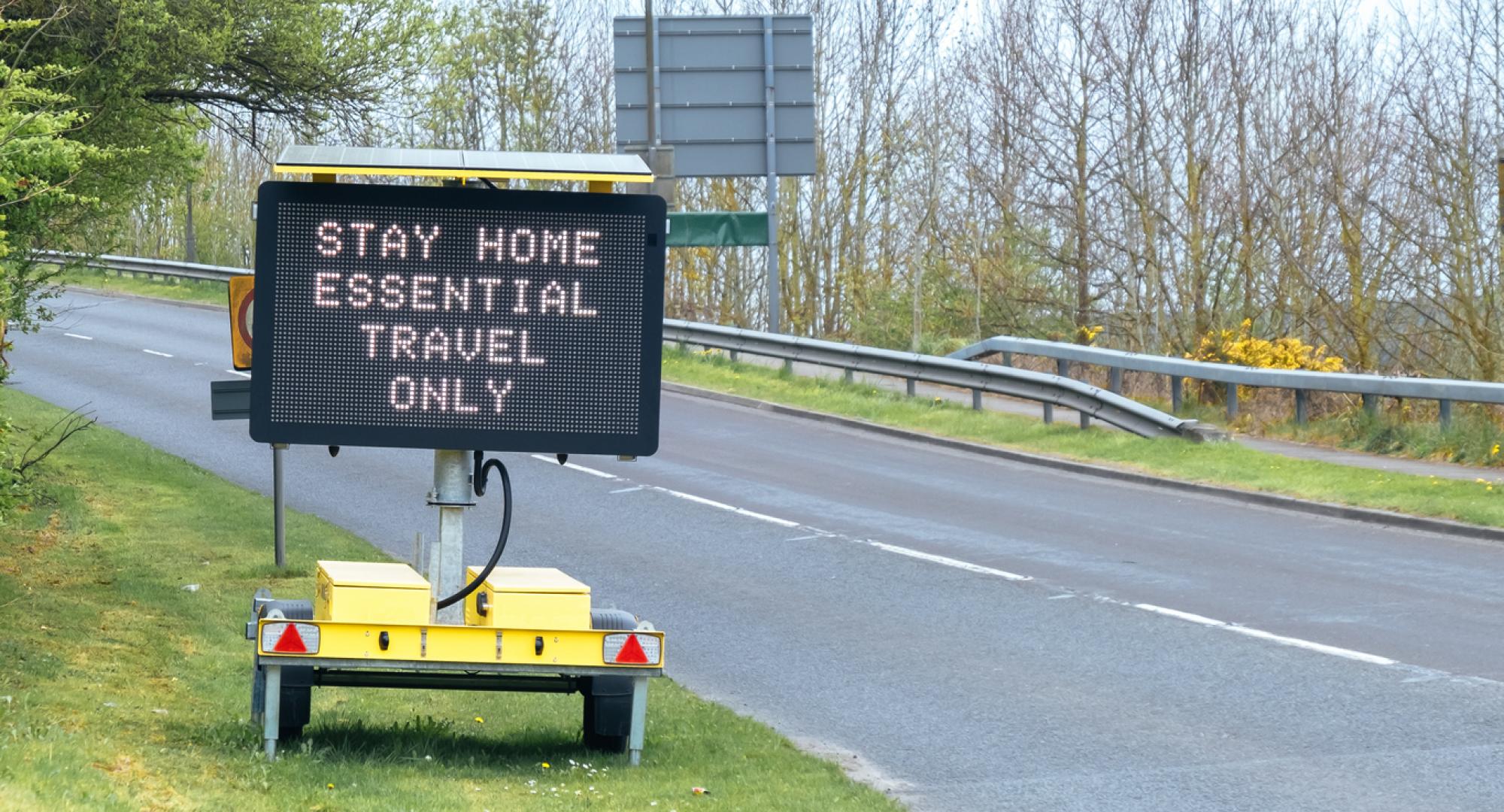 Road sign indicating essential travel only due to the Covid-19 lockdown