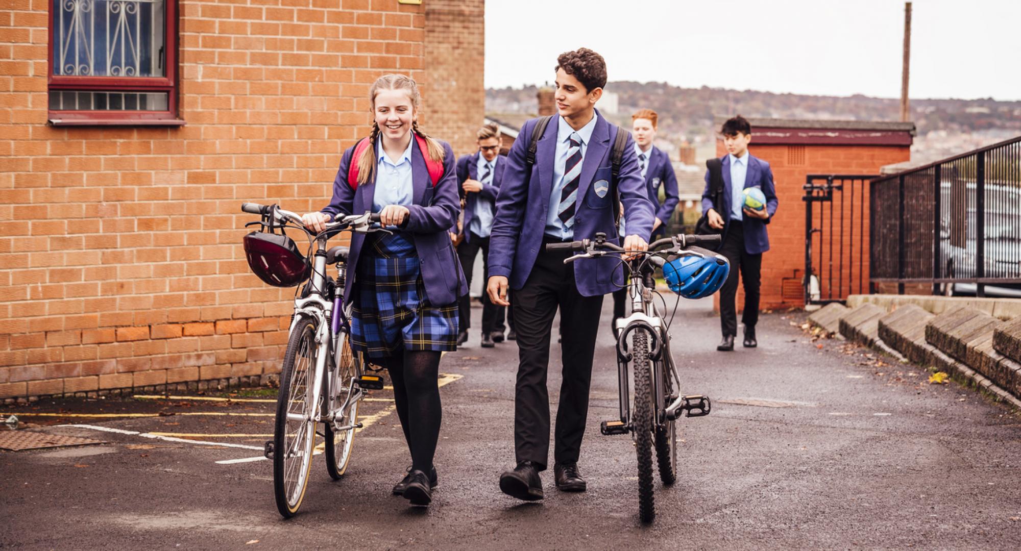 Students pushing bikes