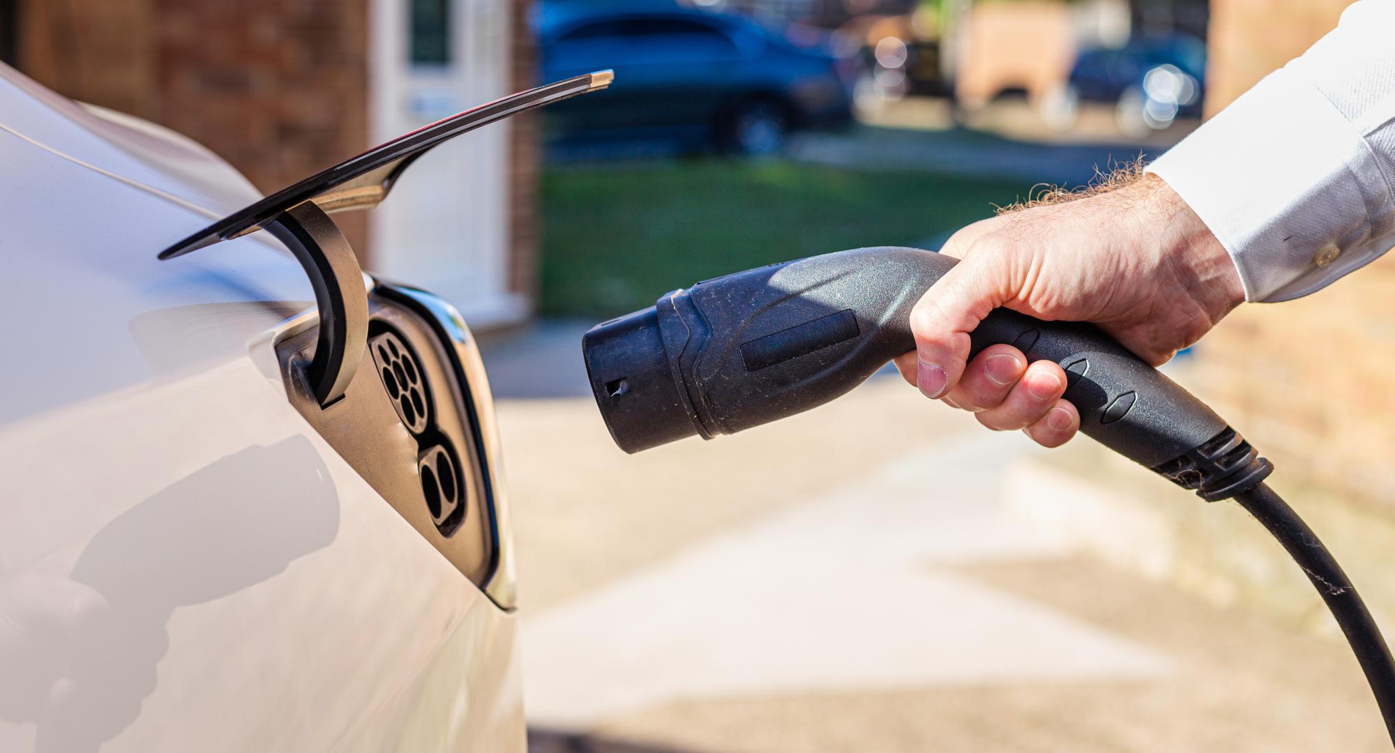 Man plugging an EV charger into his car