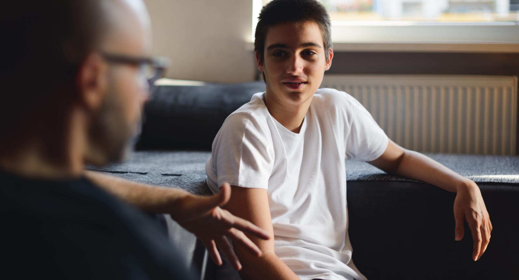 Adult man mentoring a teenage boy