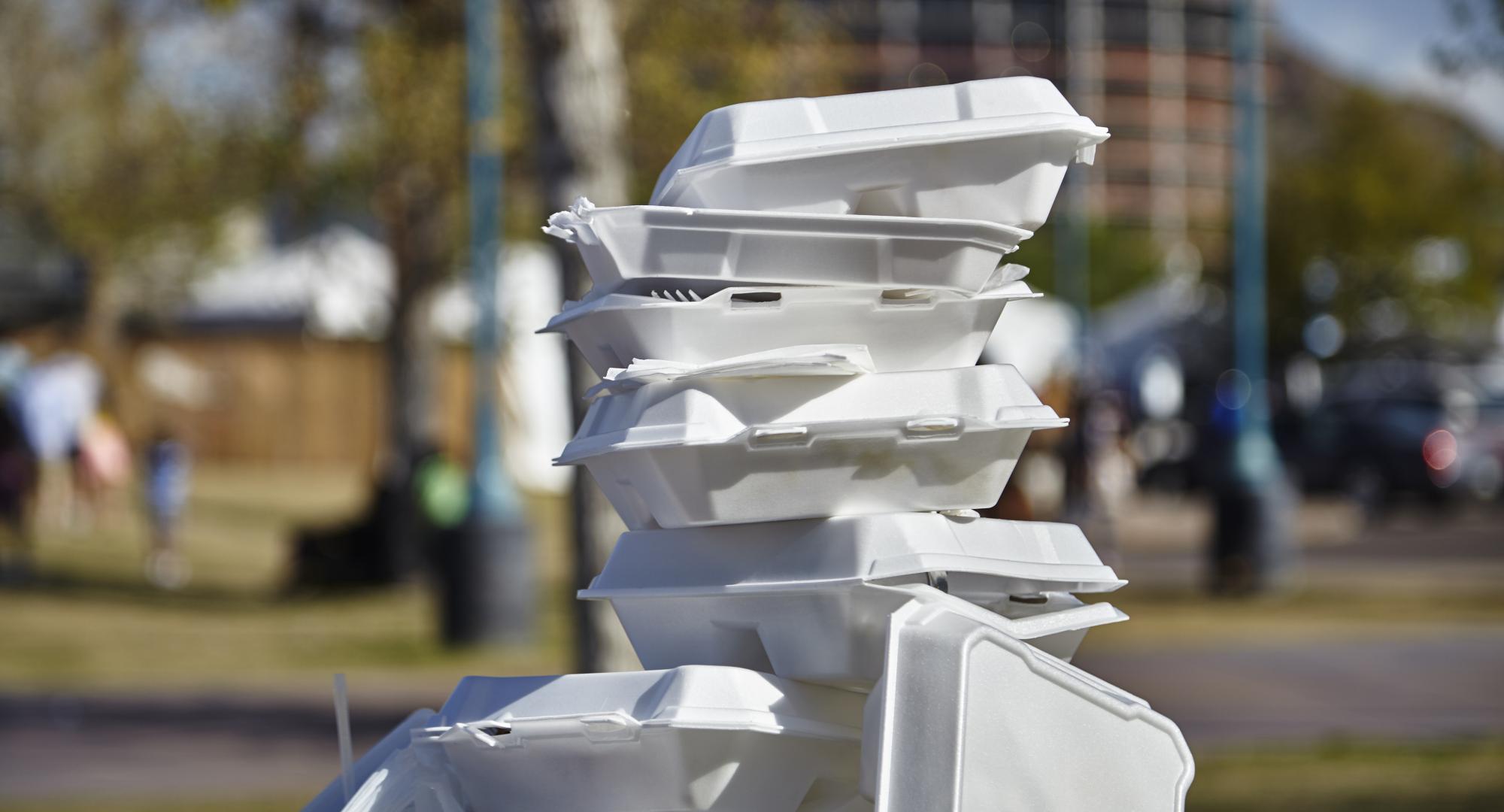 A pile of single use plastic boxes