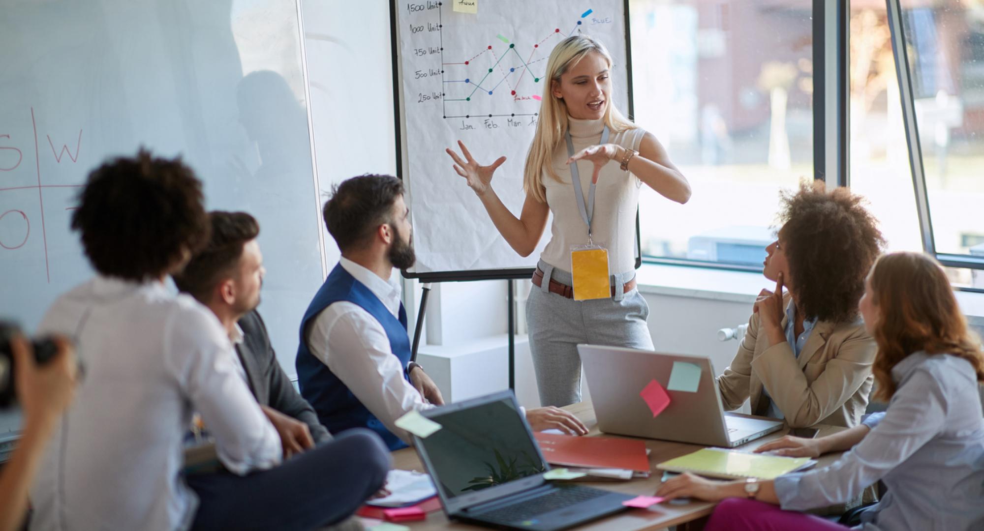 Business woman present her idea to working team