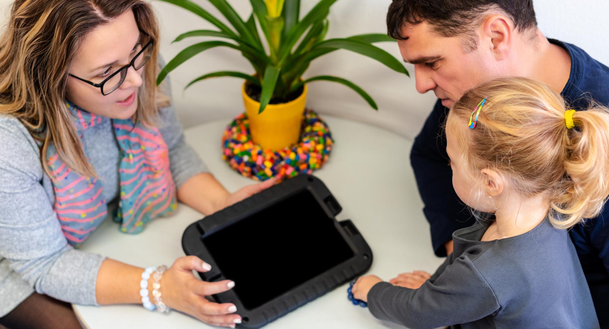 Father and toddler daughter in therapist office during counselling assessment meeting