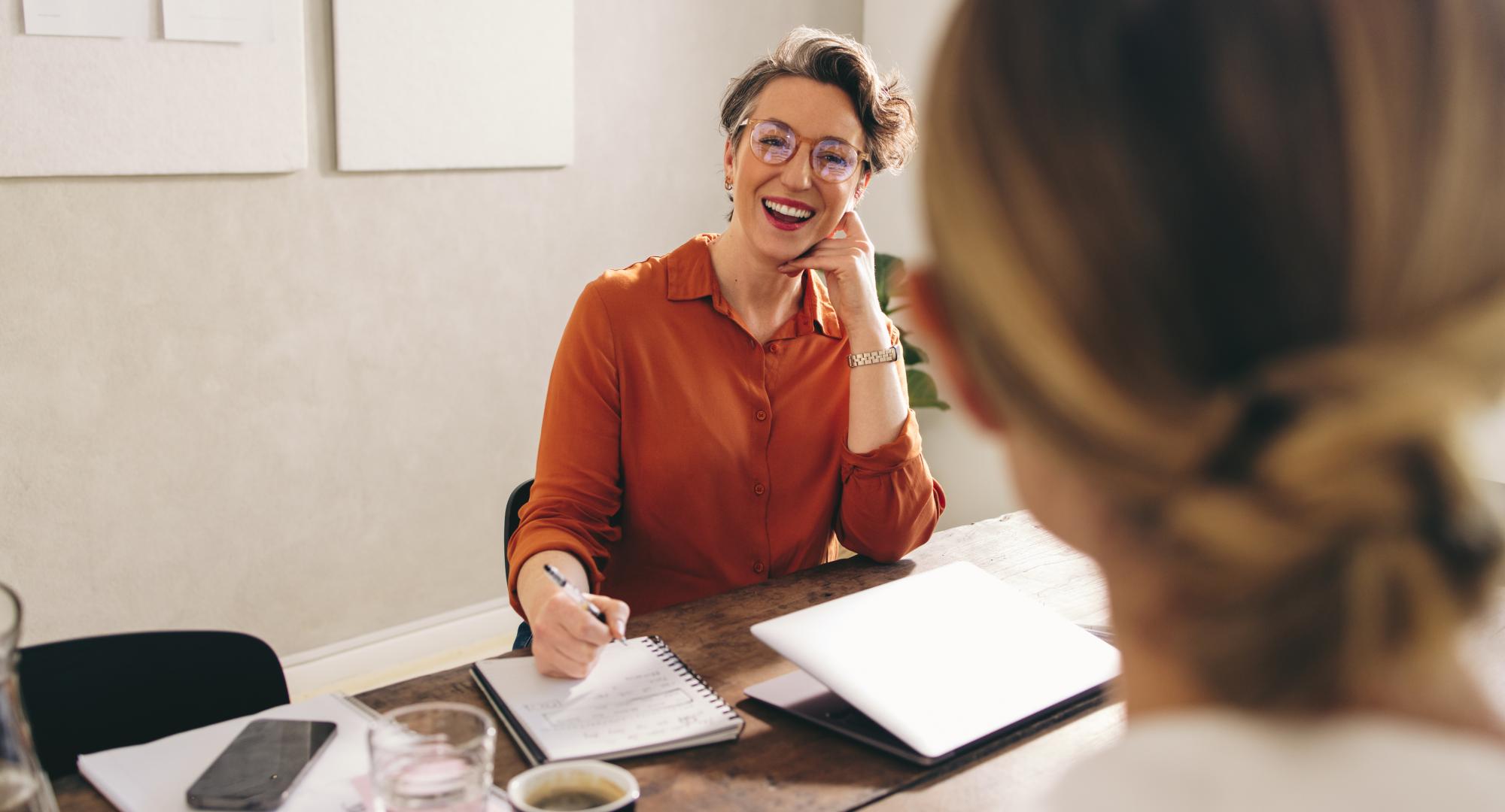 Happy businesswoman interviewing a job candidate