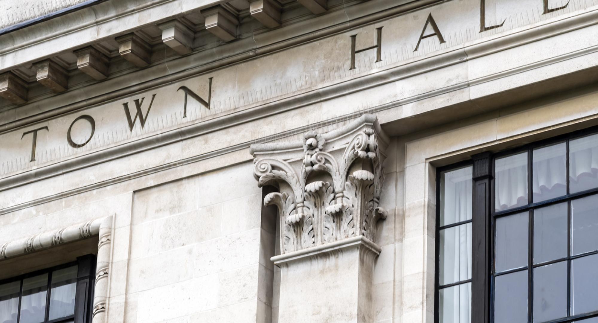 Town hall sign on exterior of local government office