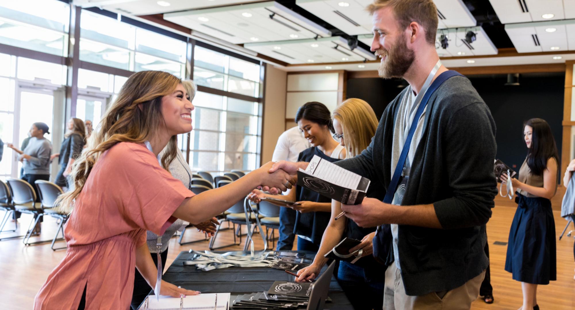 Two people meeting at a careers fair