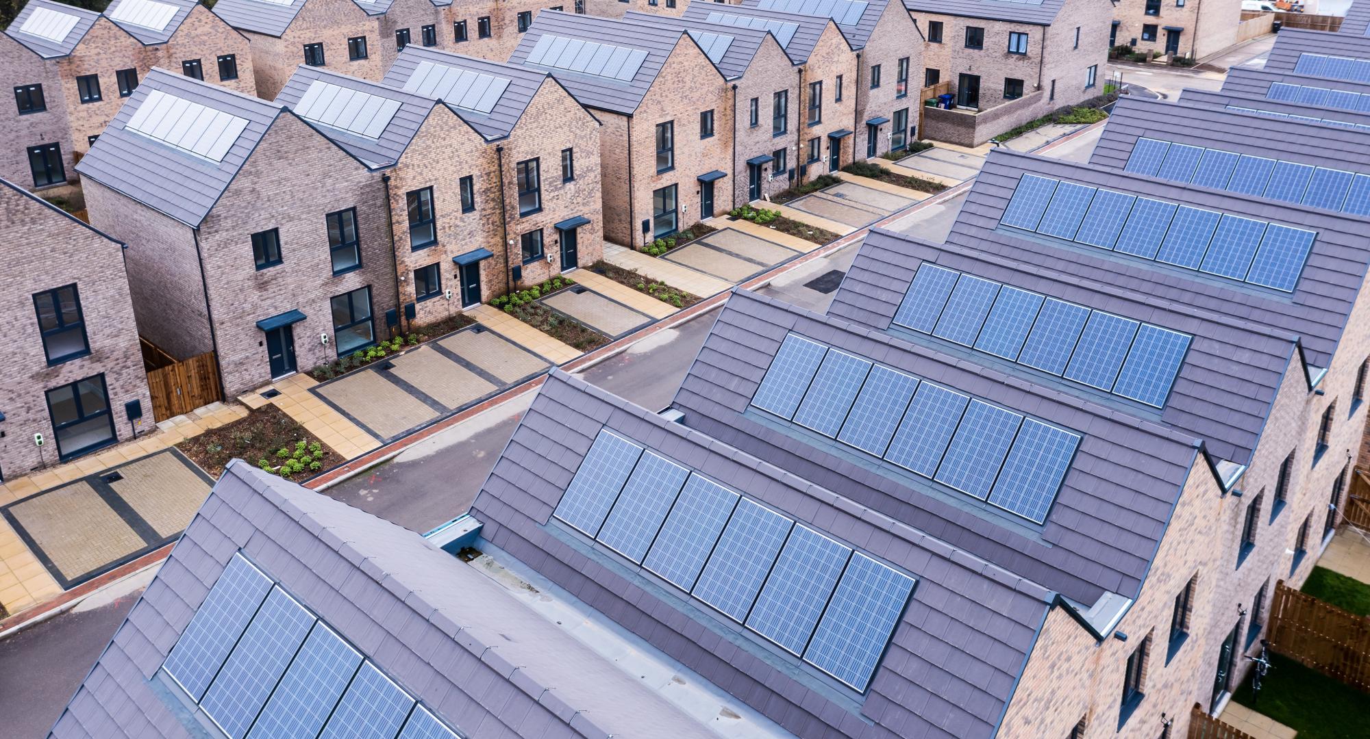 Aerial view of rows of energy efficient new build modular terraced houses in the UK