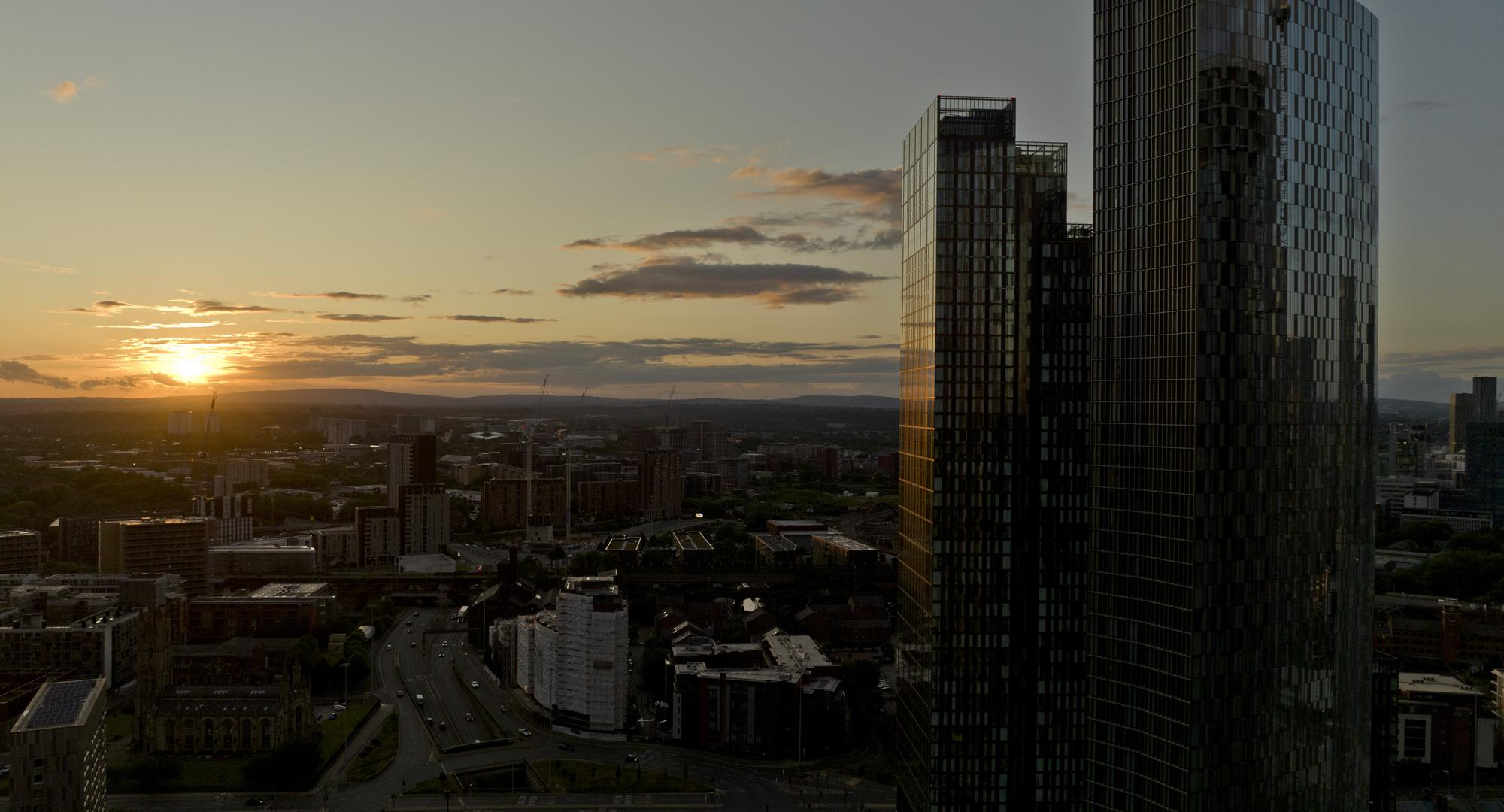 An aerial photograph of downtown Manchester at sunset