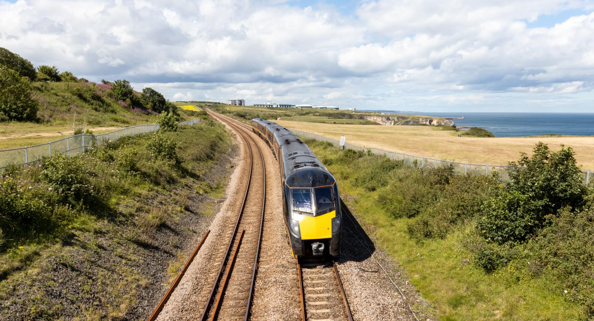 Durham Heritage Coast East Coast mainline train passing by the sea on a summer day