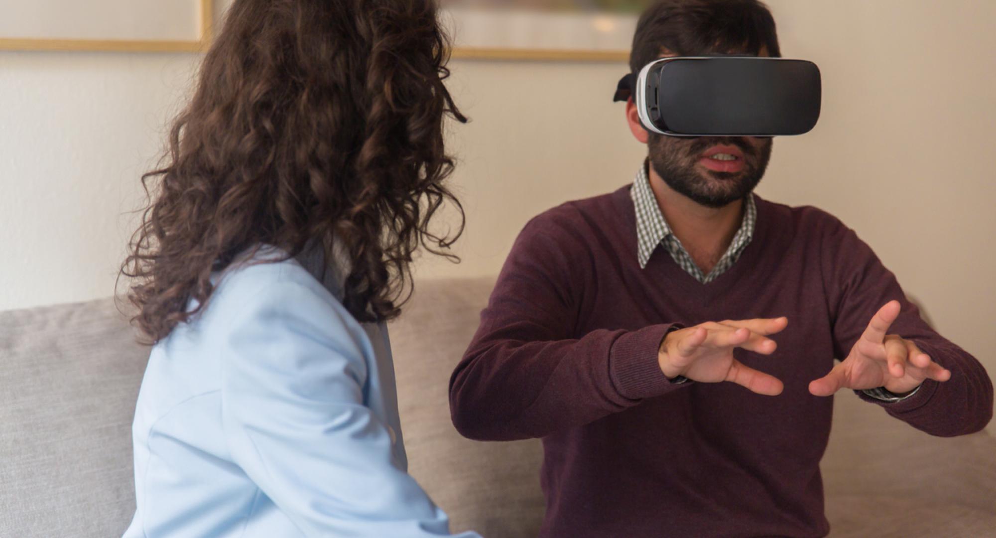 Front view of tranquil young man testing virtual reality headset