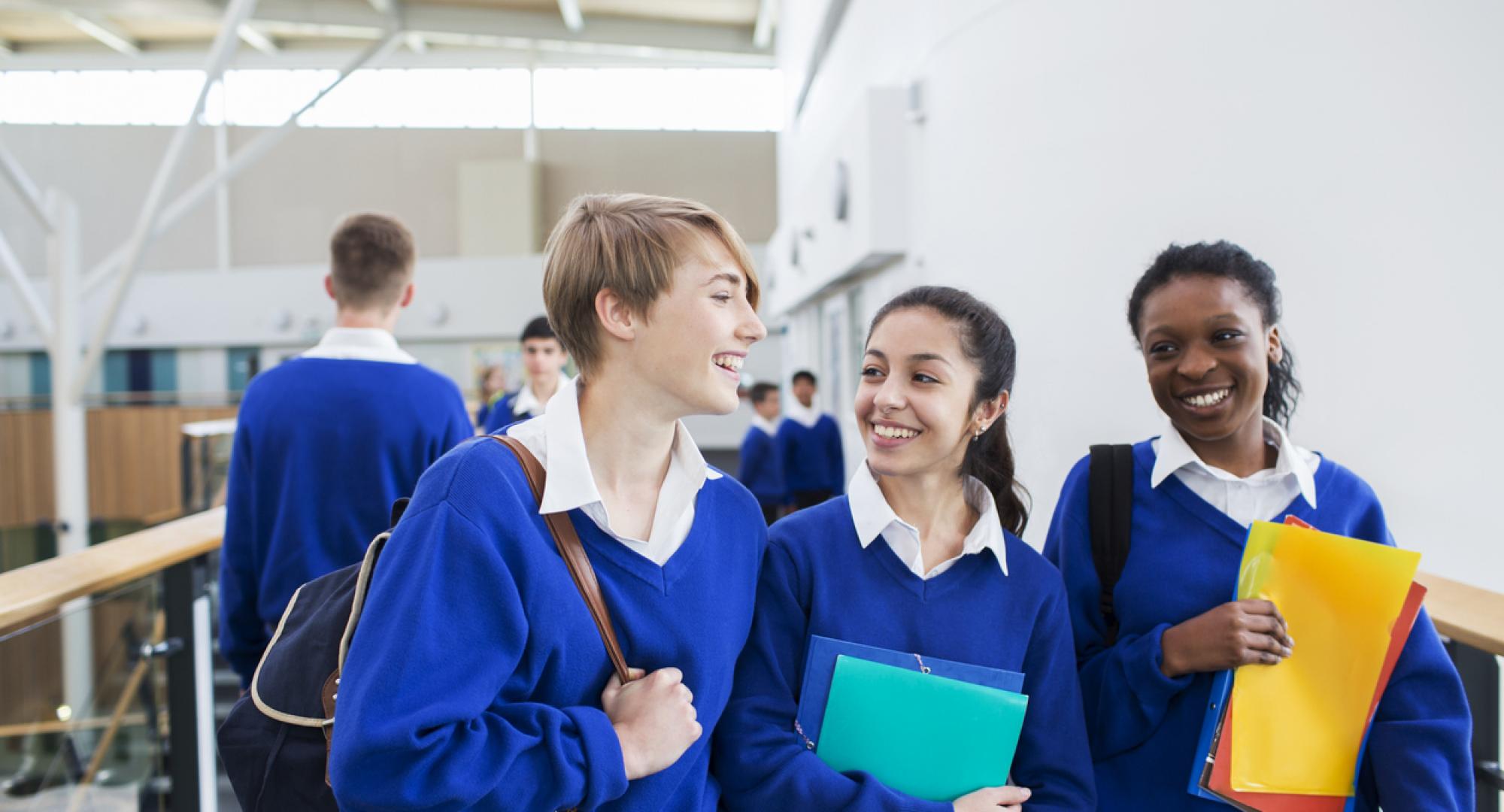 Smiling female students wearing school uniforms