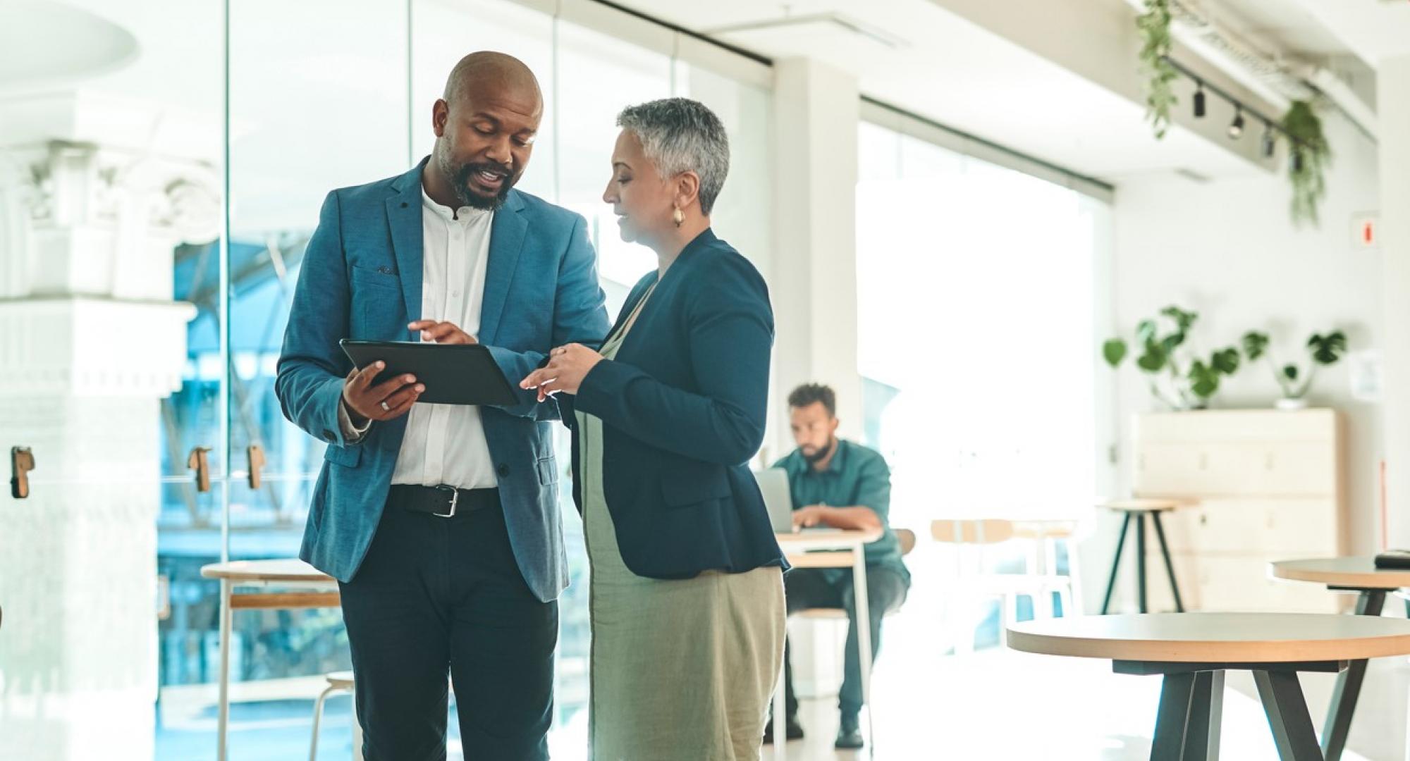 Business people talking around a tablet