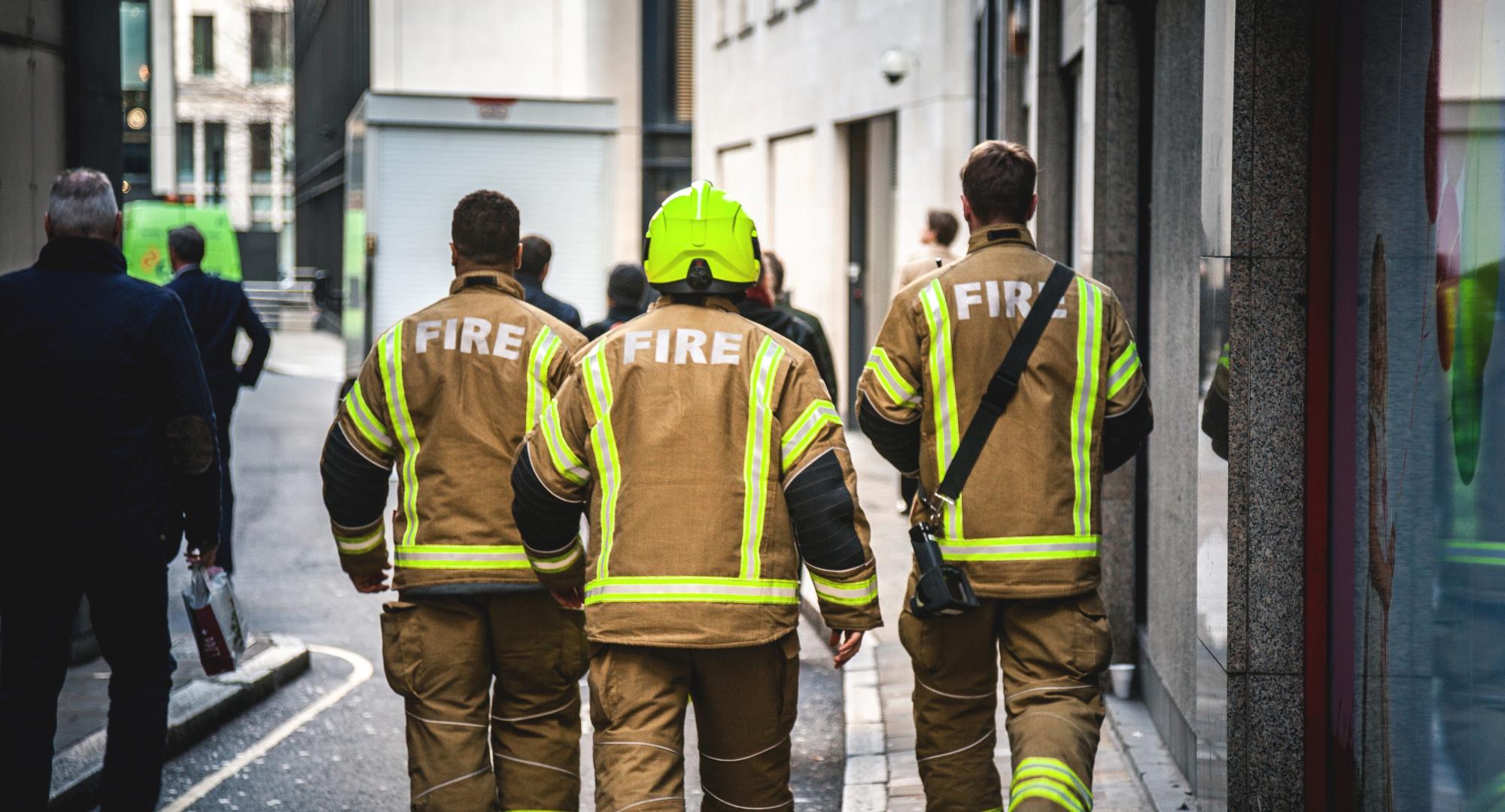 Three firefighters walking in London