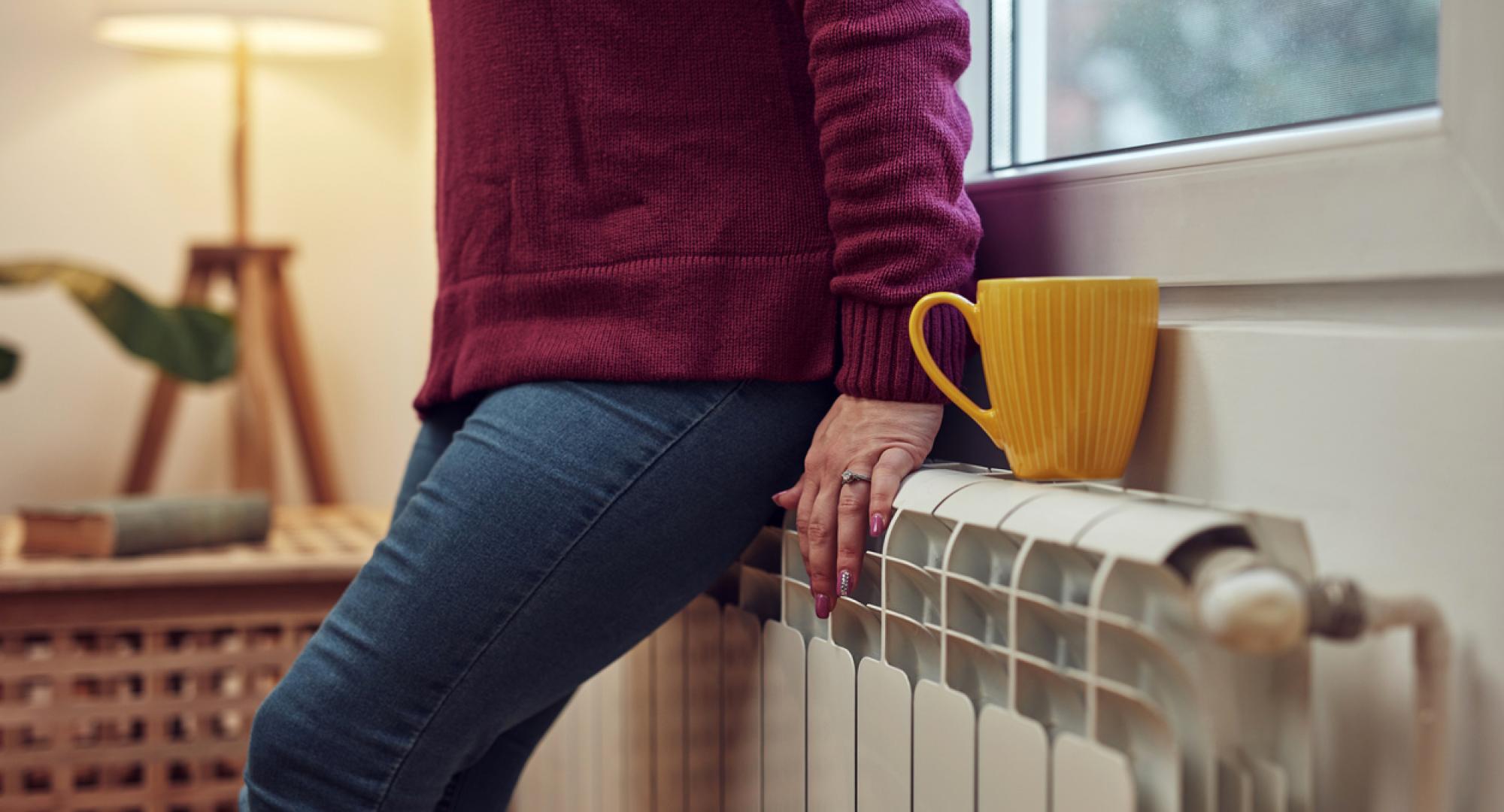 Woman heating on a chilly winter day