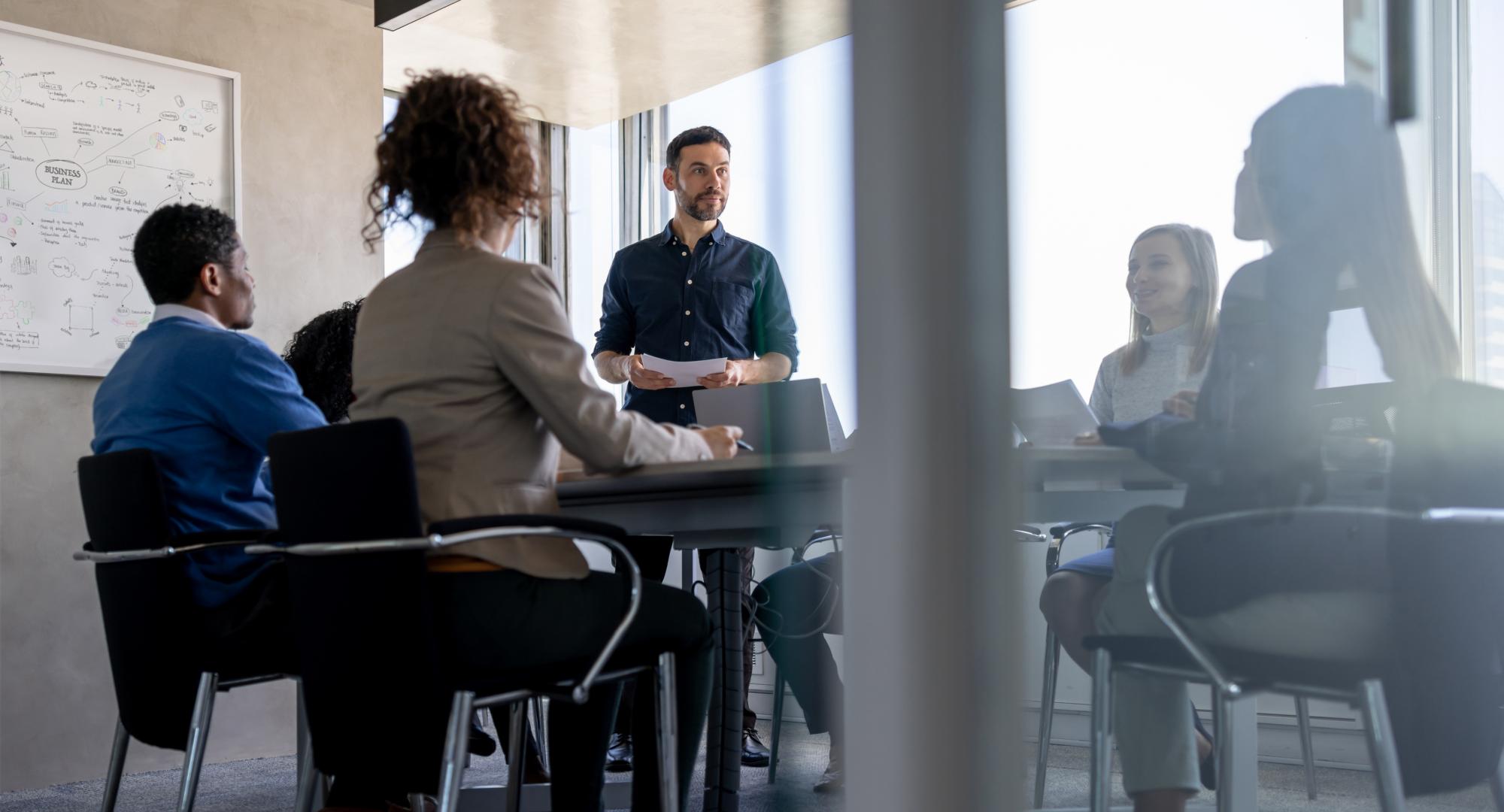 man talking to his team in a meeting at the office