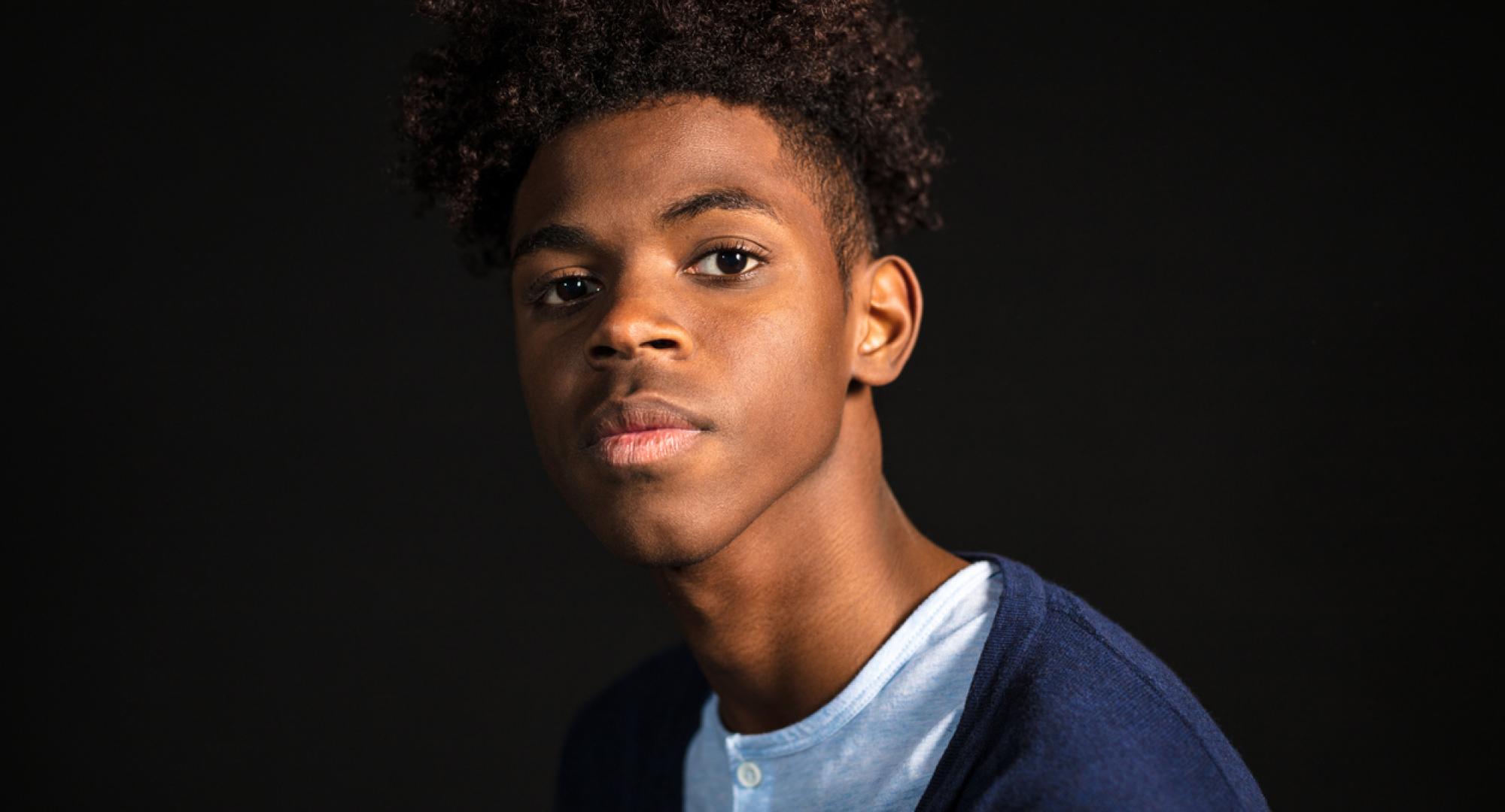 Close-up portrait of confident young man in casuals looking at camera