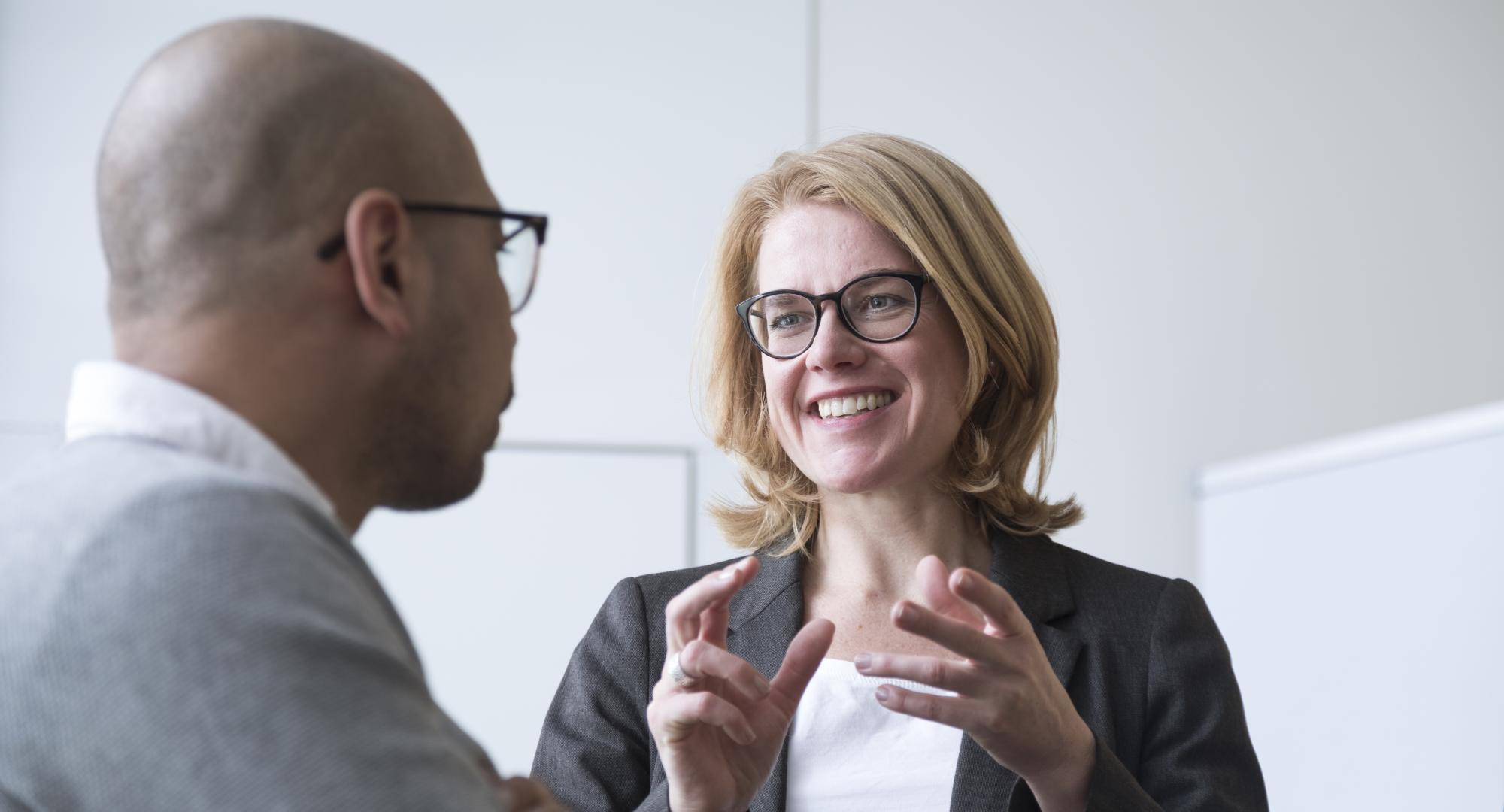 Two people, one of them a CFO, talking and discussing roles