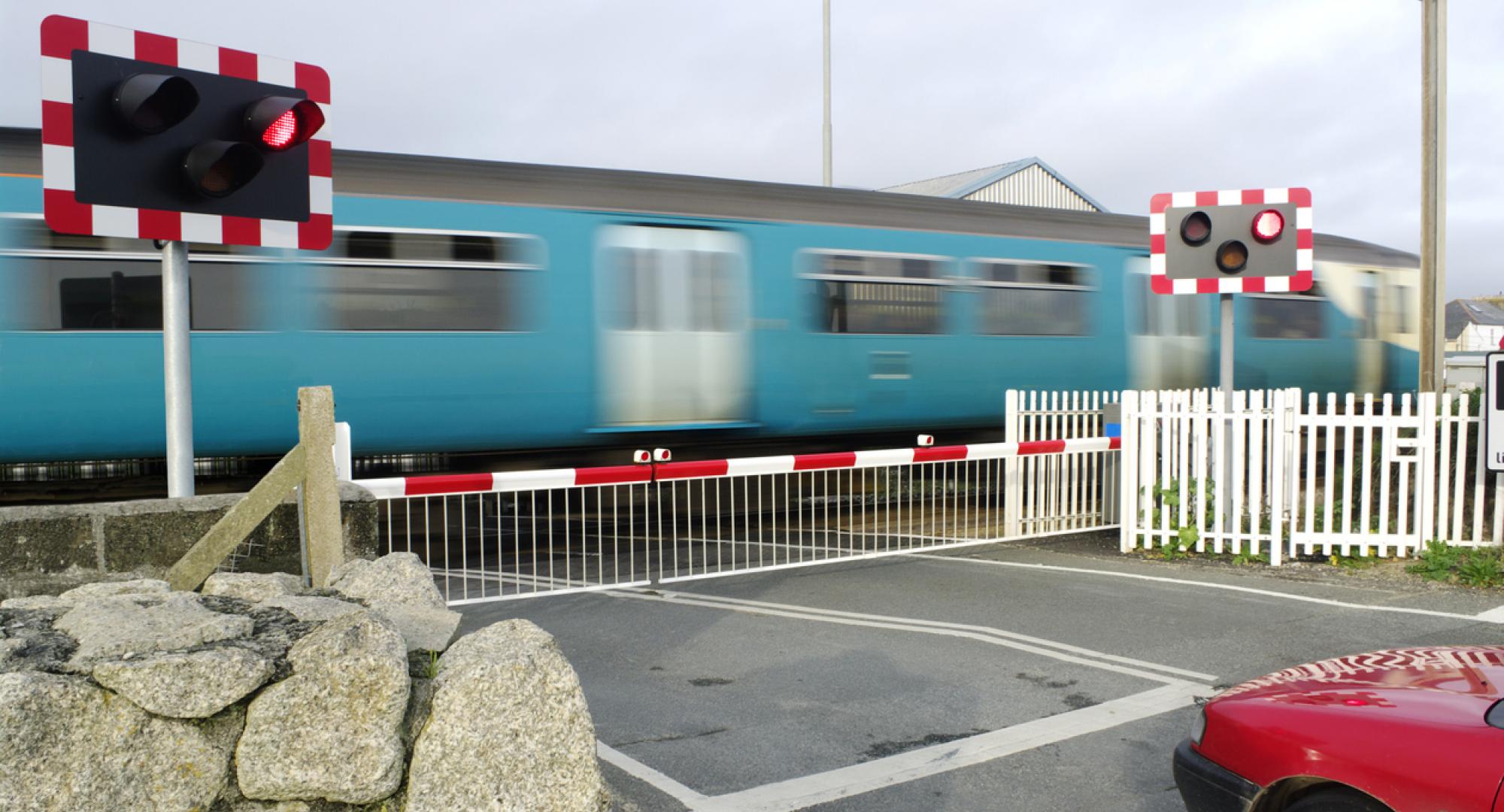 Motion Blurred Train At Level Crossing Cornwall UK