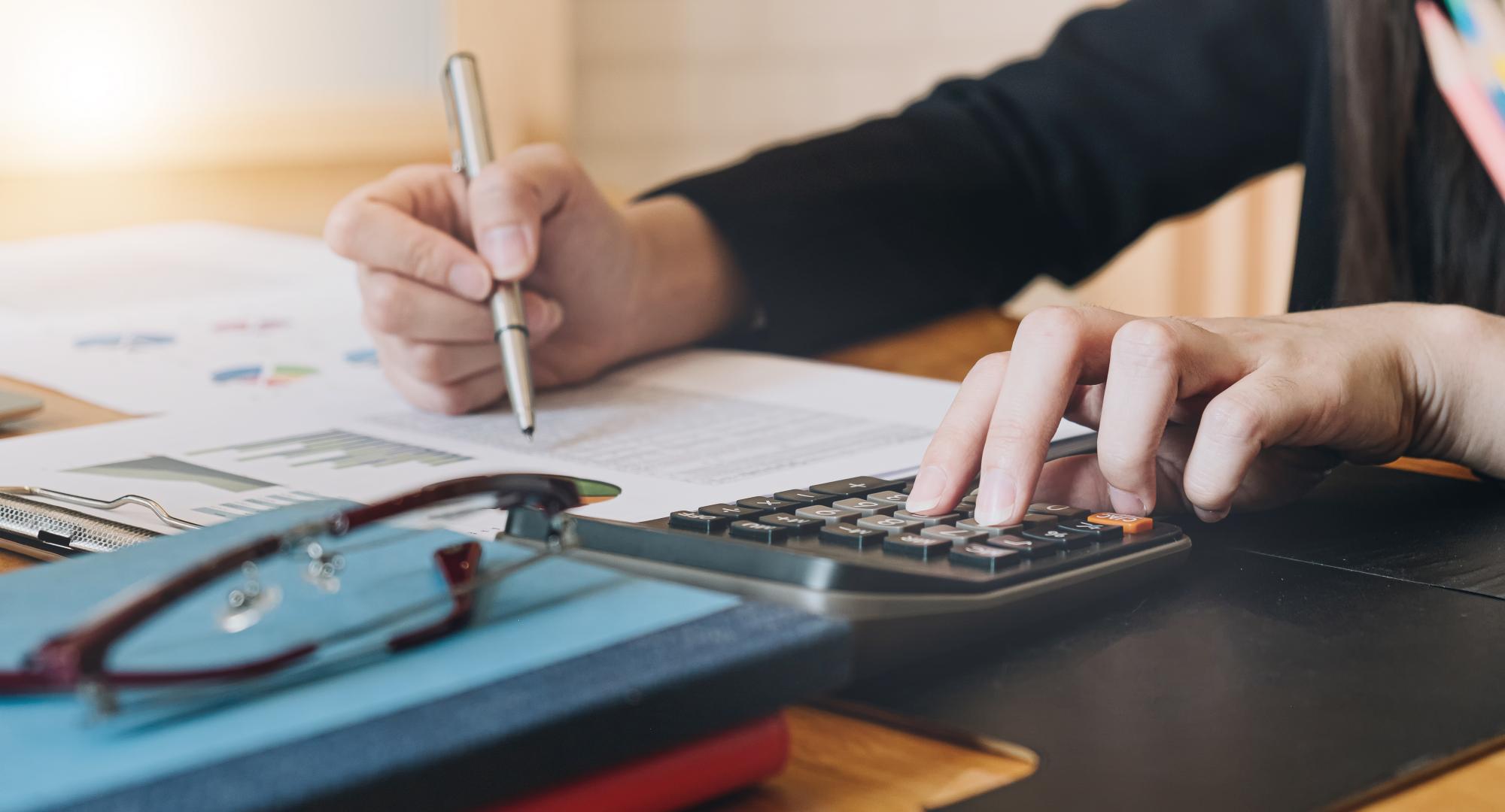 Accountant working with calculator for investigation