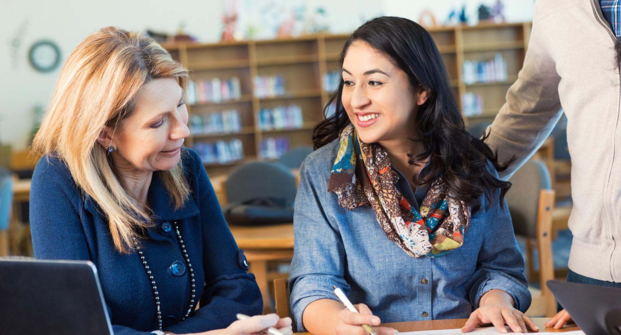 Adult college student talking to professor