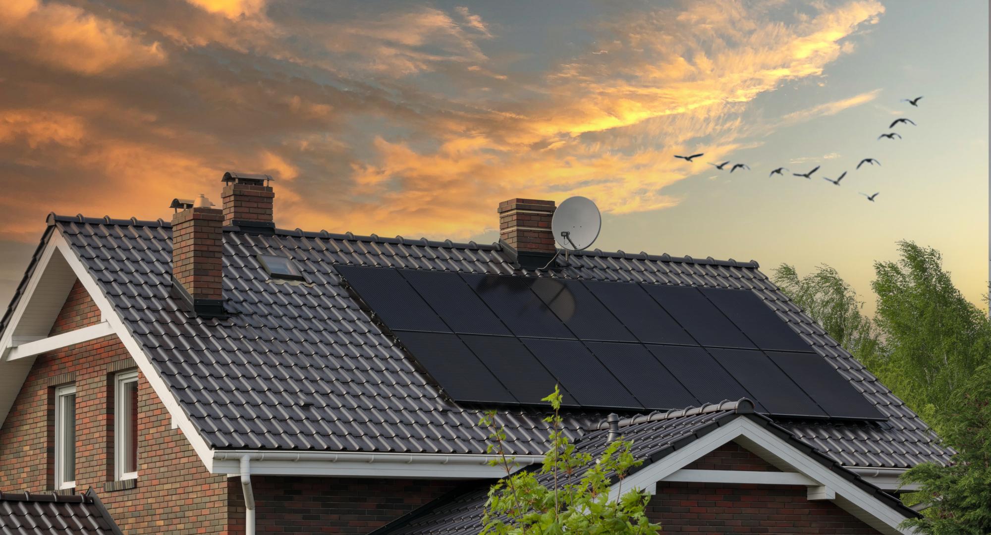 Brick house, solar panels, beautiful sunset.