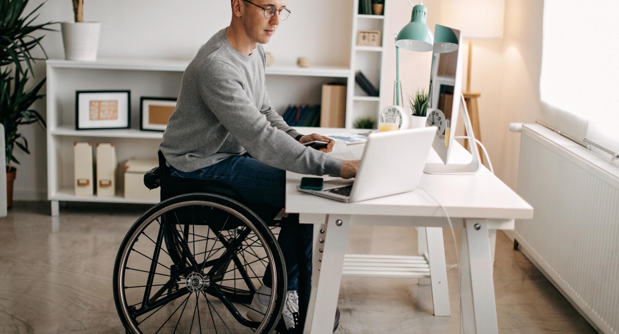 Young man with disabilities working on computer