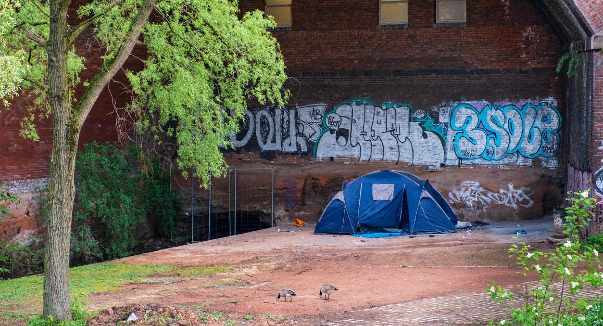 a tent hosting homeless people by the canal in Castlefield, Manchester