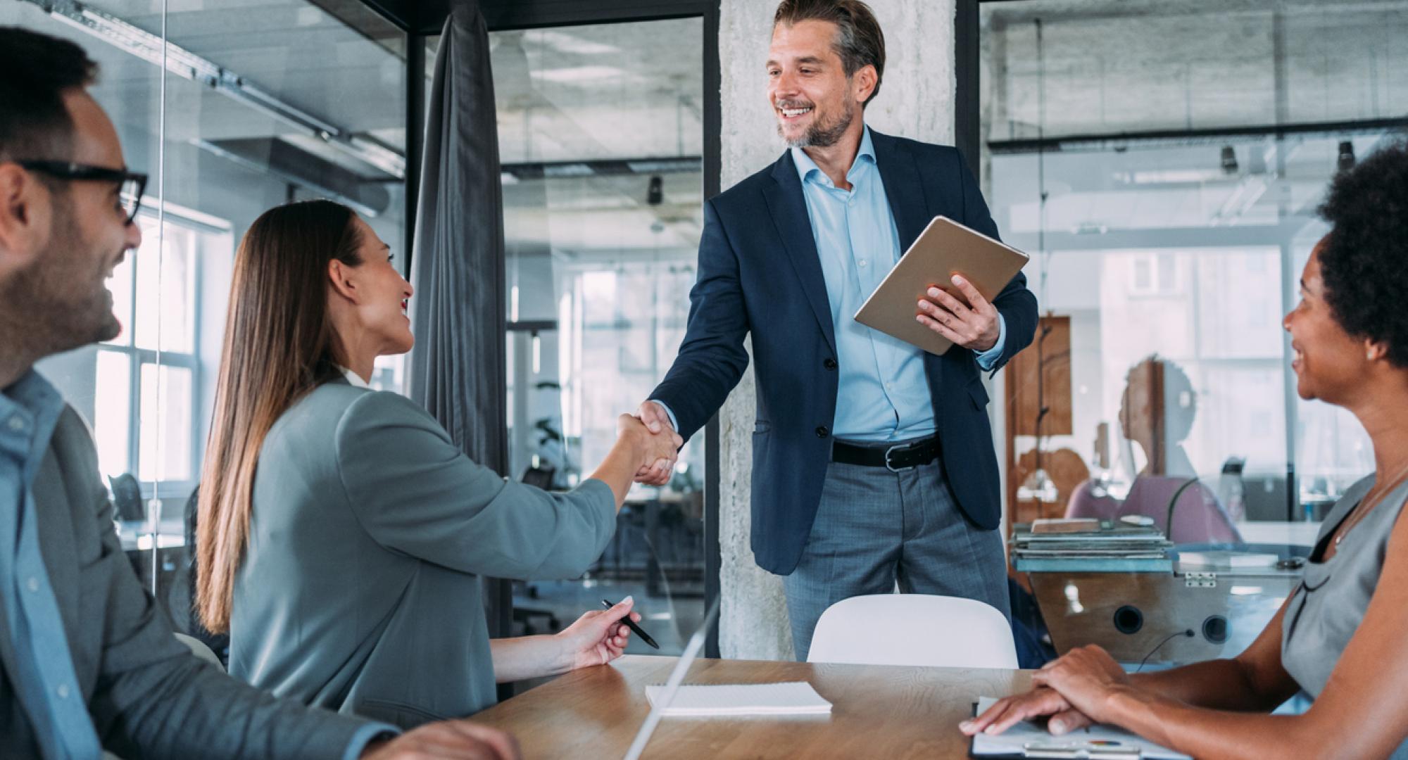 Businesswoman and businessman shaking hands