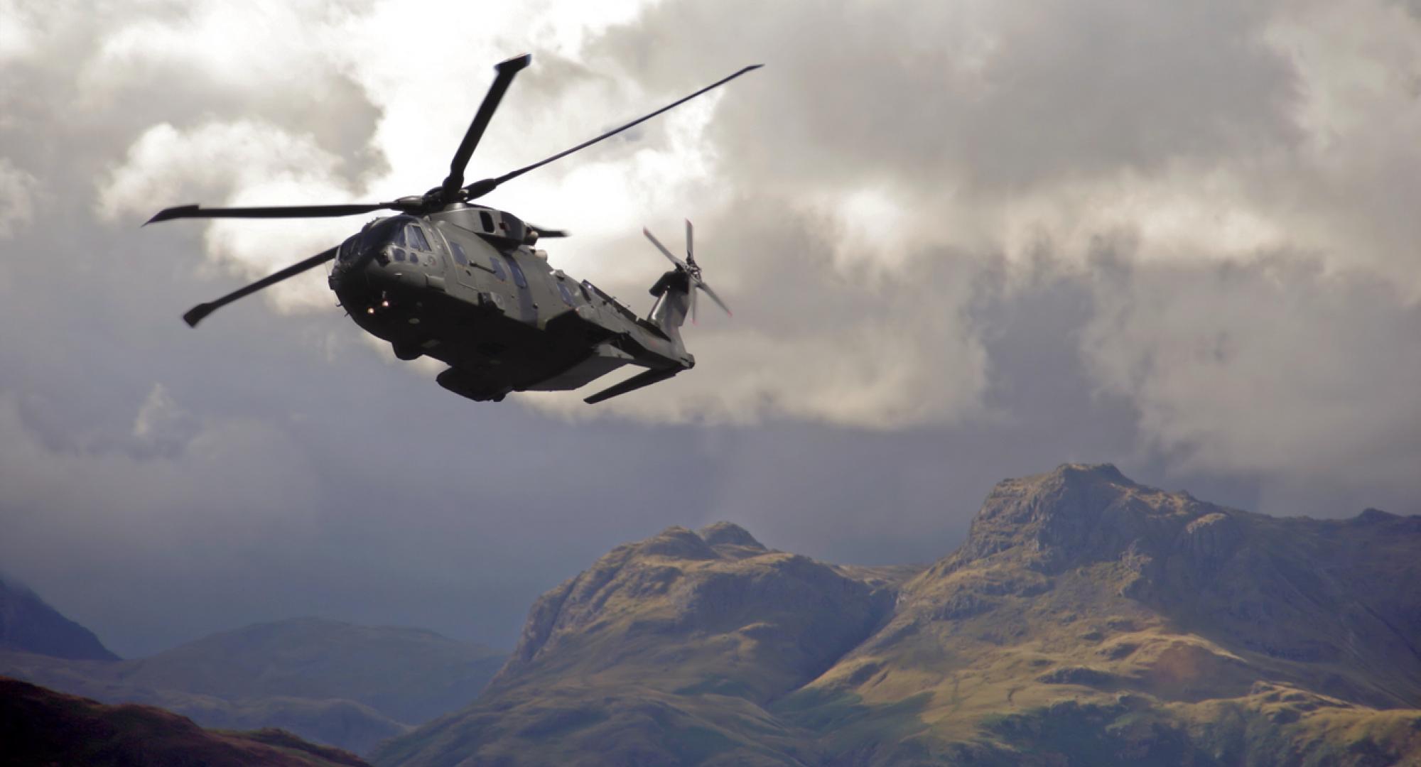 RAF Merlin helicopter hugs valleys in the lake district mountains