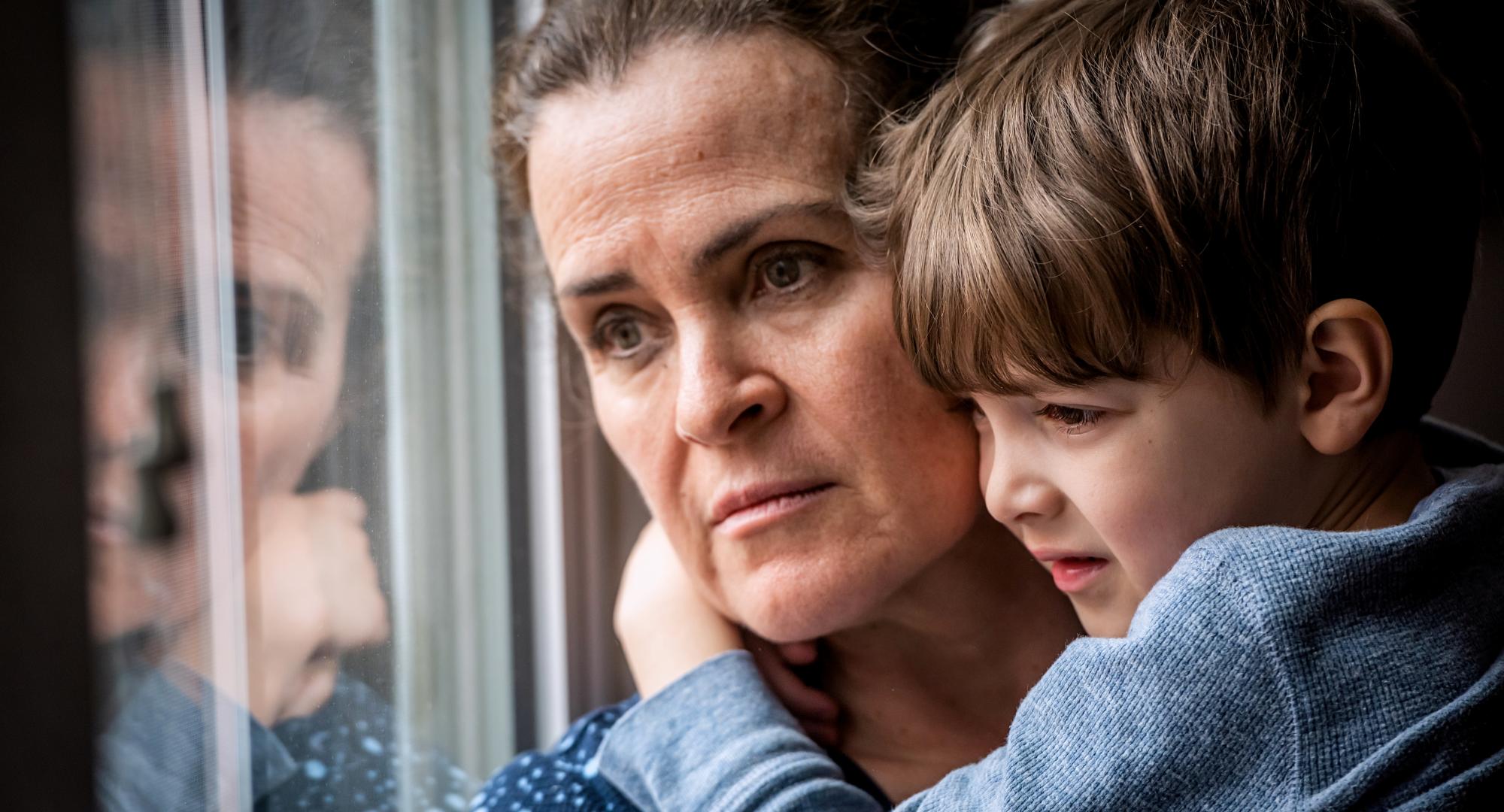 Pensive Mature woman posing with her son