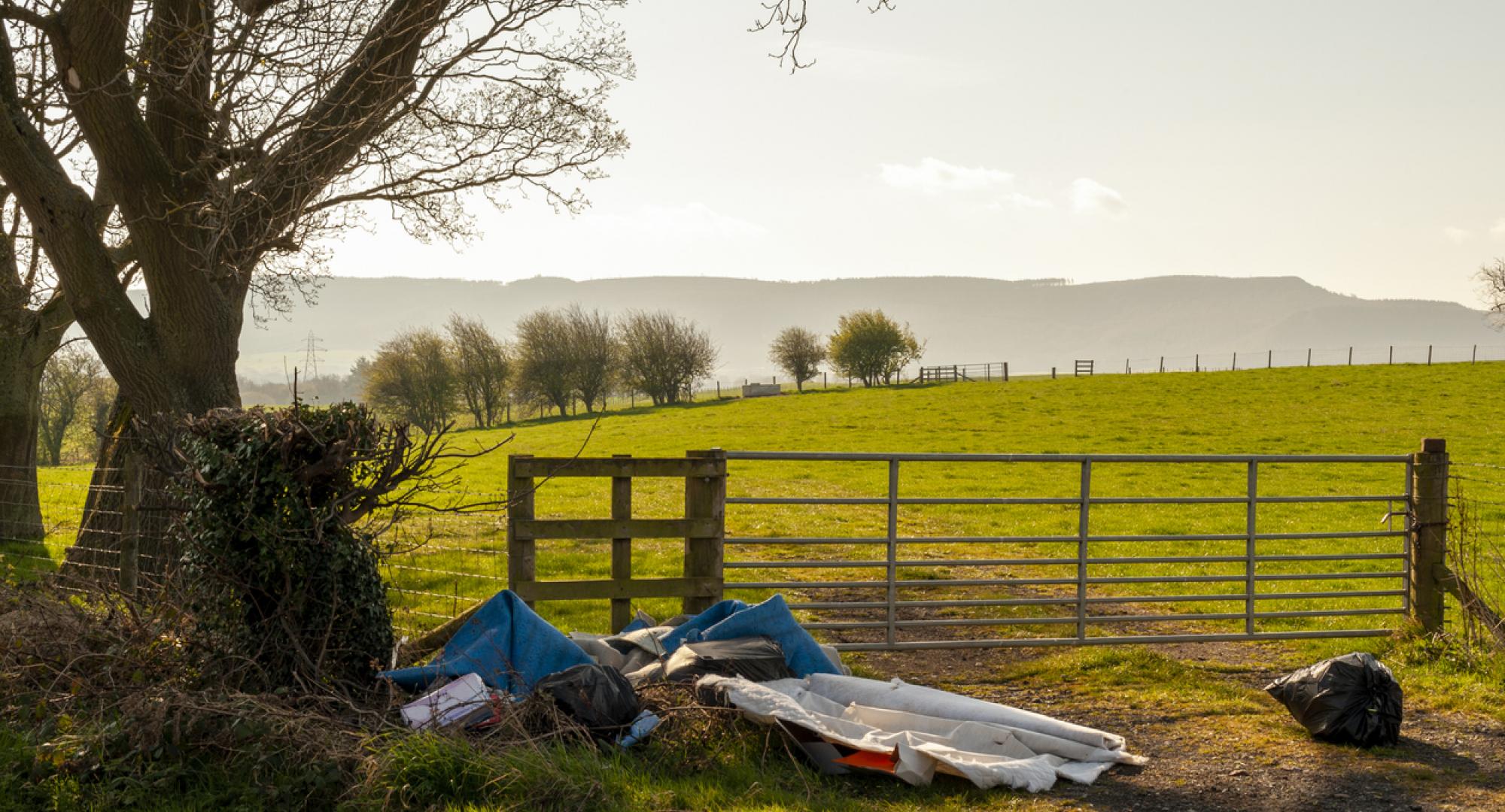 Illegal Fly Tipping by a Farmers Gate on a Quiet Rural Lane