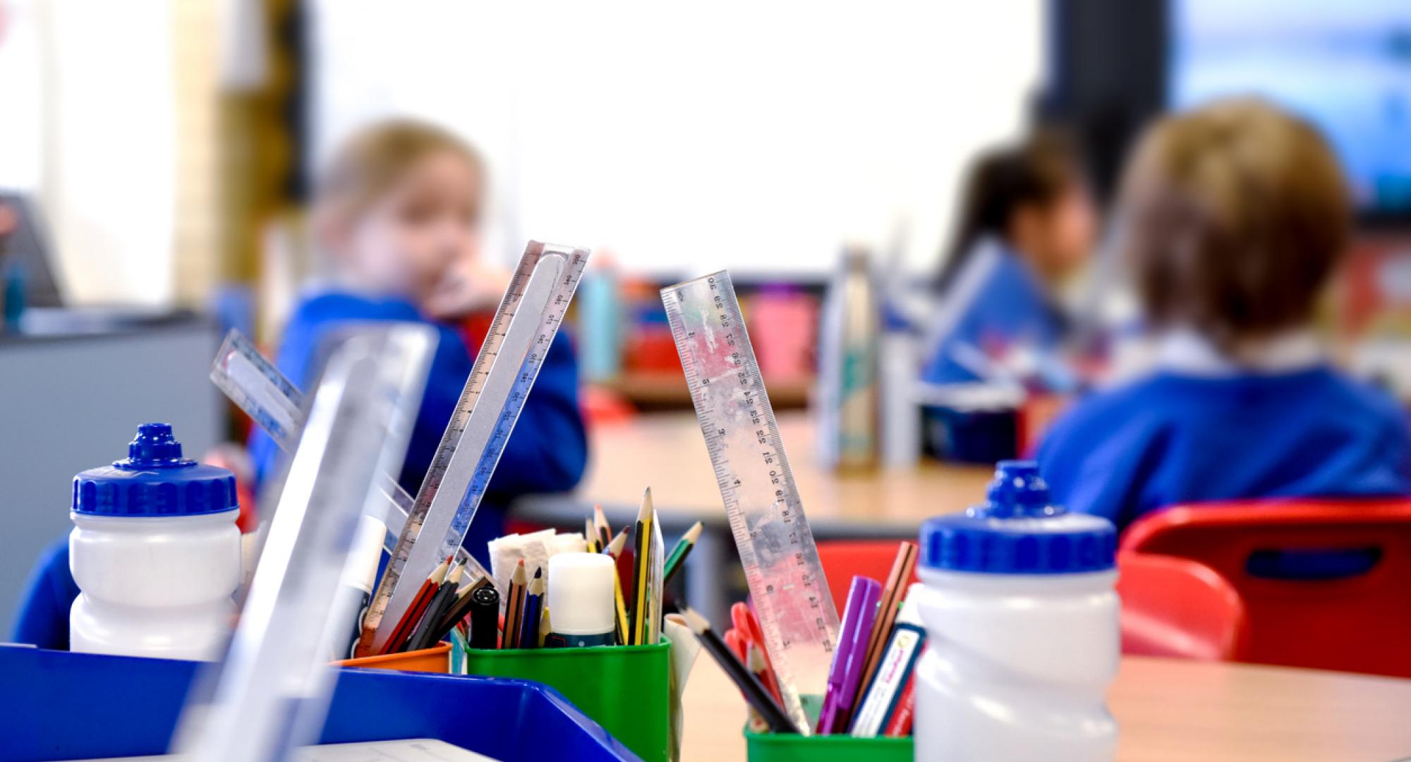 School classroom scene with kids learning in background
