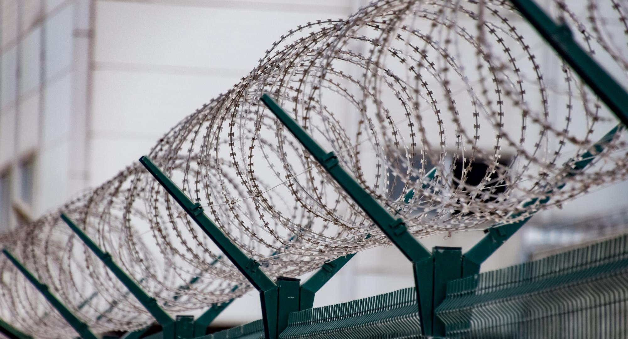 Barbed wire on the top of a prison fence