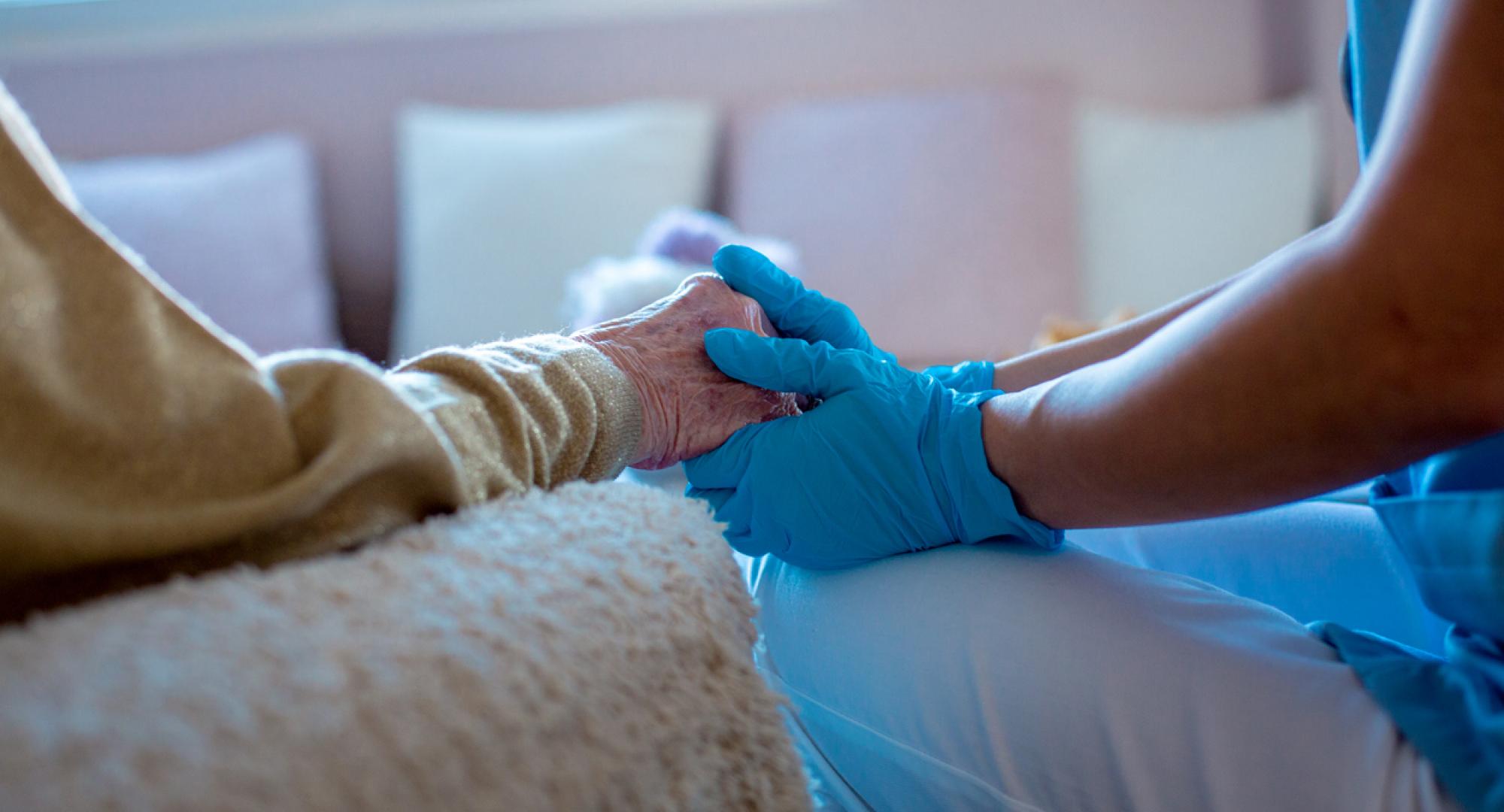 Nurse providing care at home for an older patient