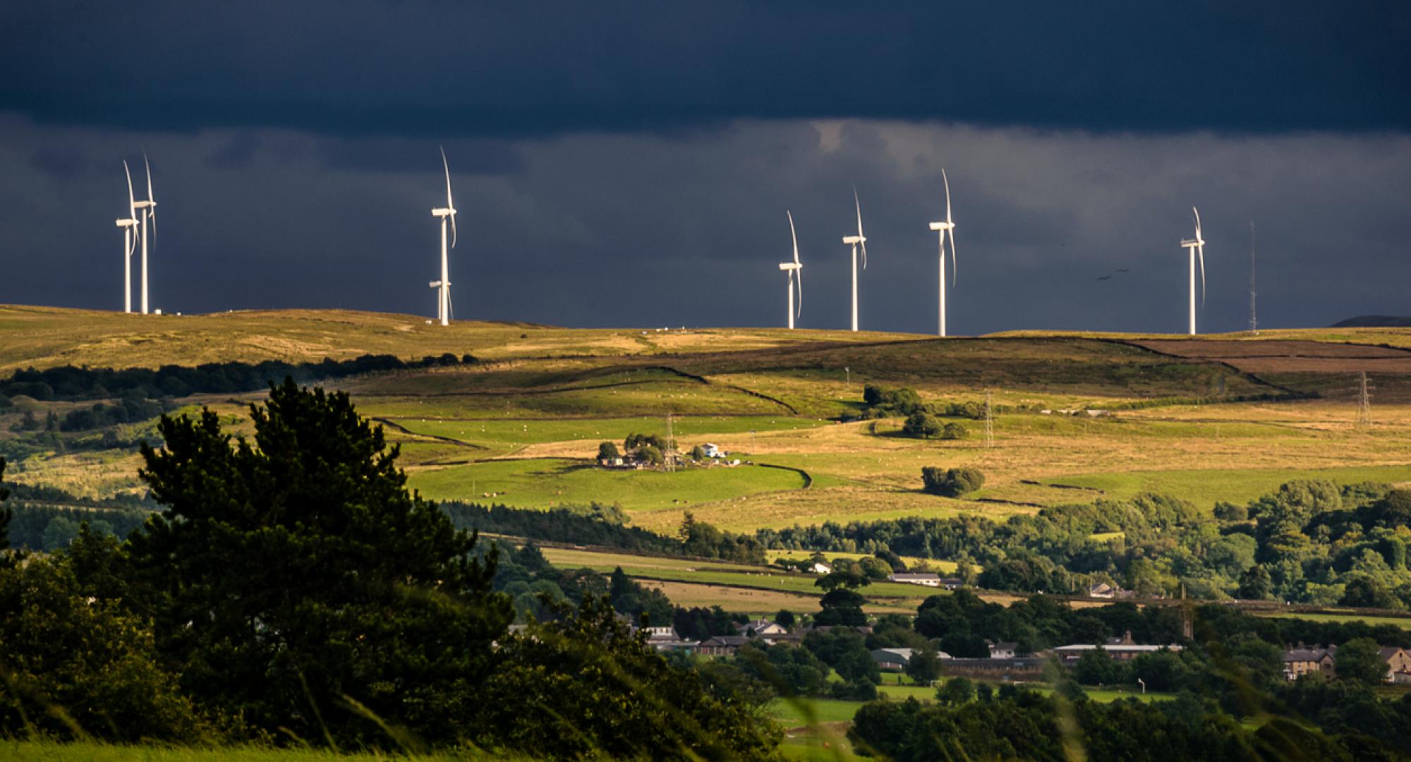 wind turbines and clouds over a farm and hills in Lancashire, England UK
