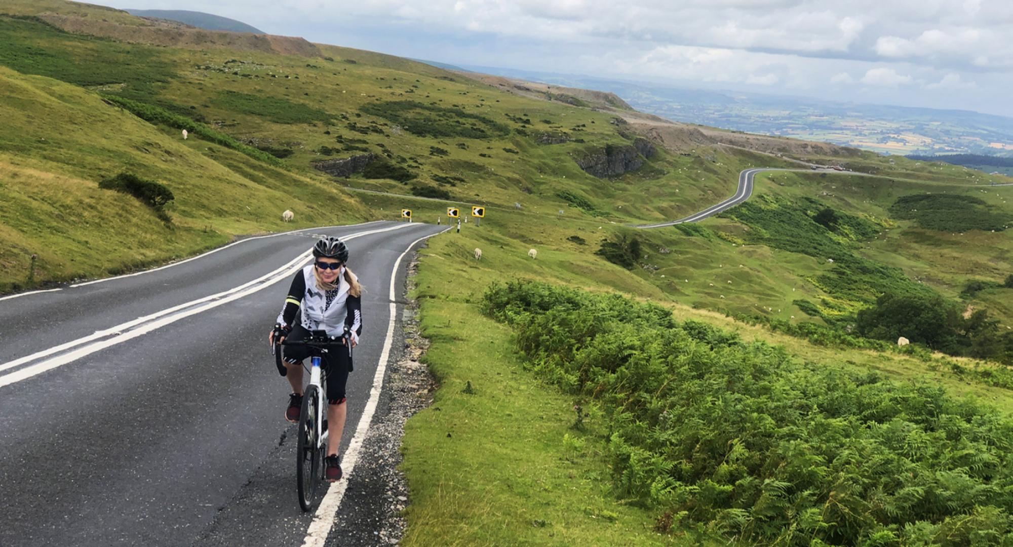 Female cyclist riding in Brecon Beacons, Wales