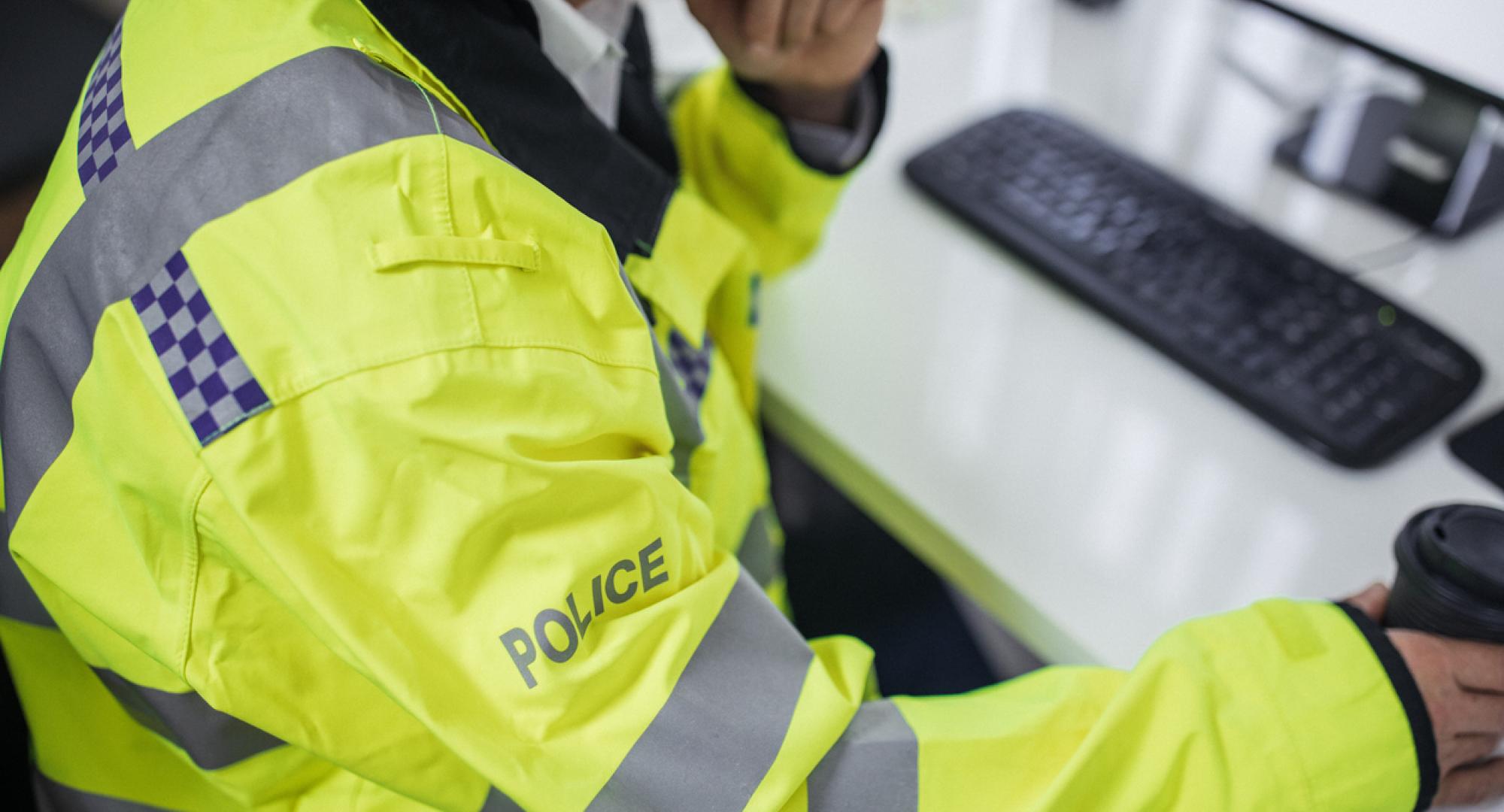 Police officer using digital system on a computer