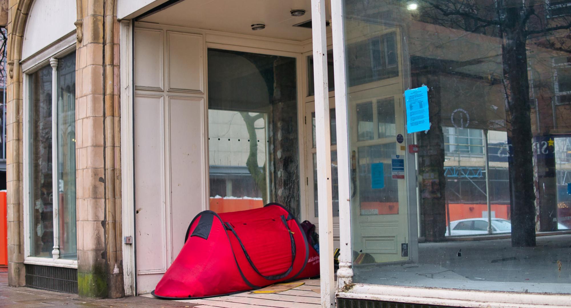 Tent in the doorway of a closed shop in the UK