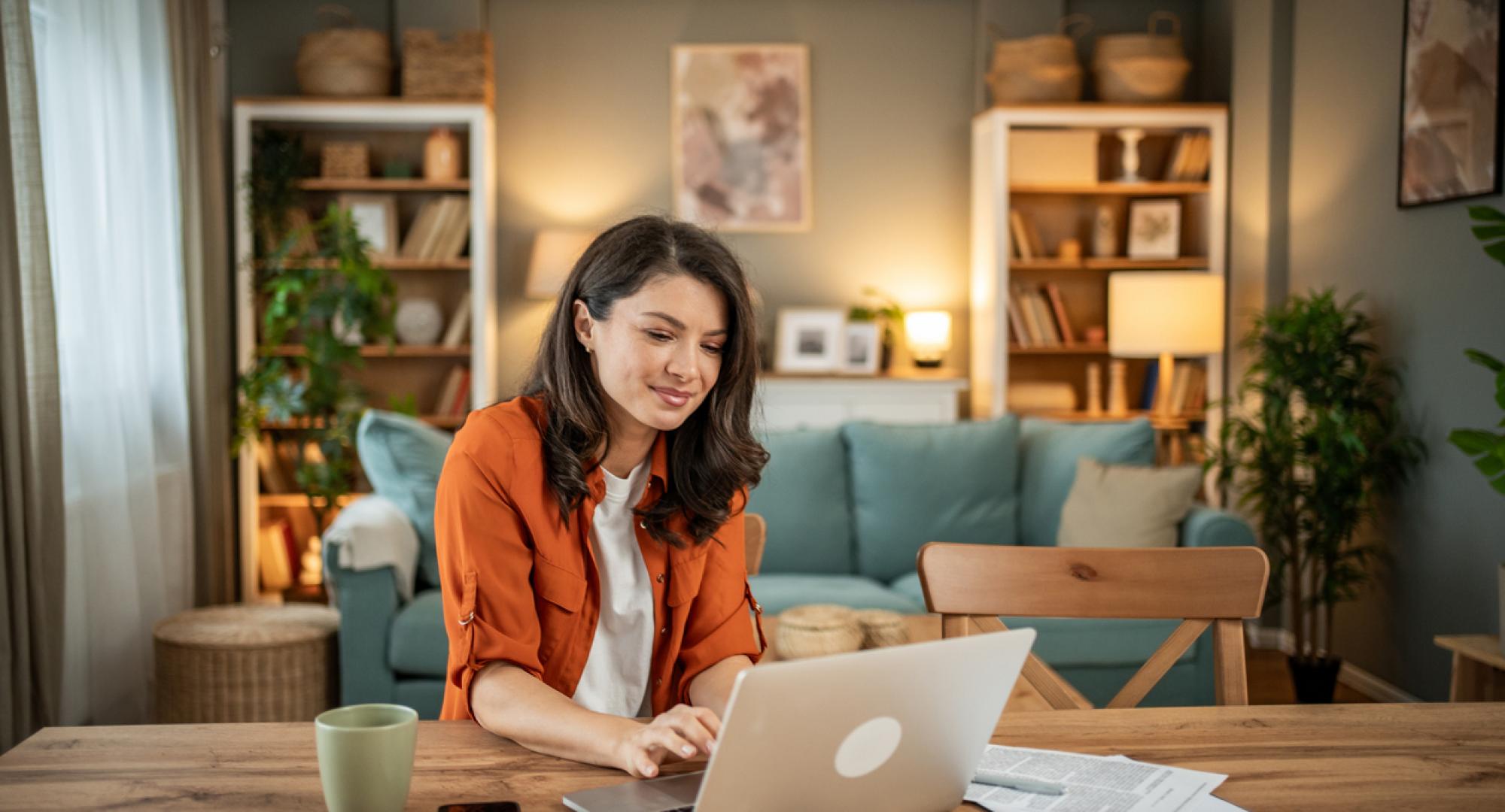 A young woman using a computer at home
