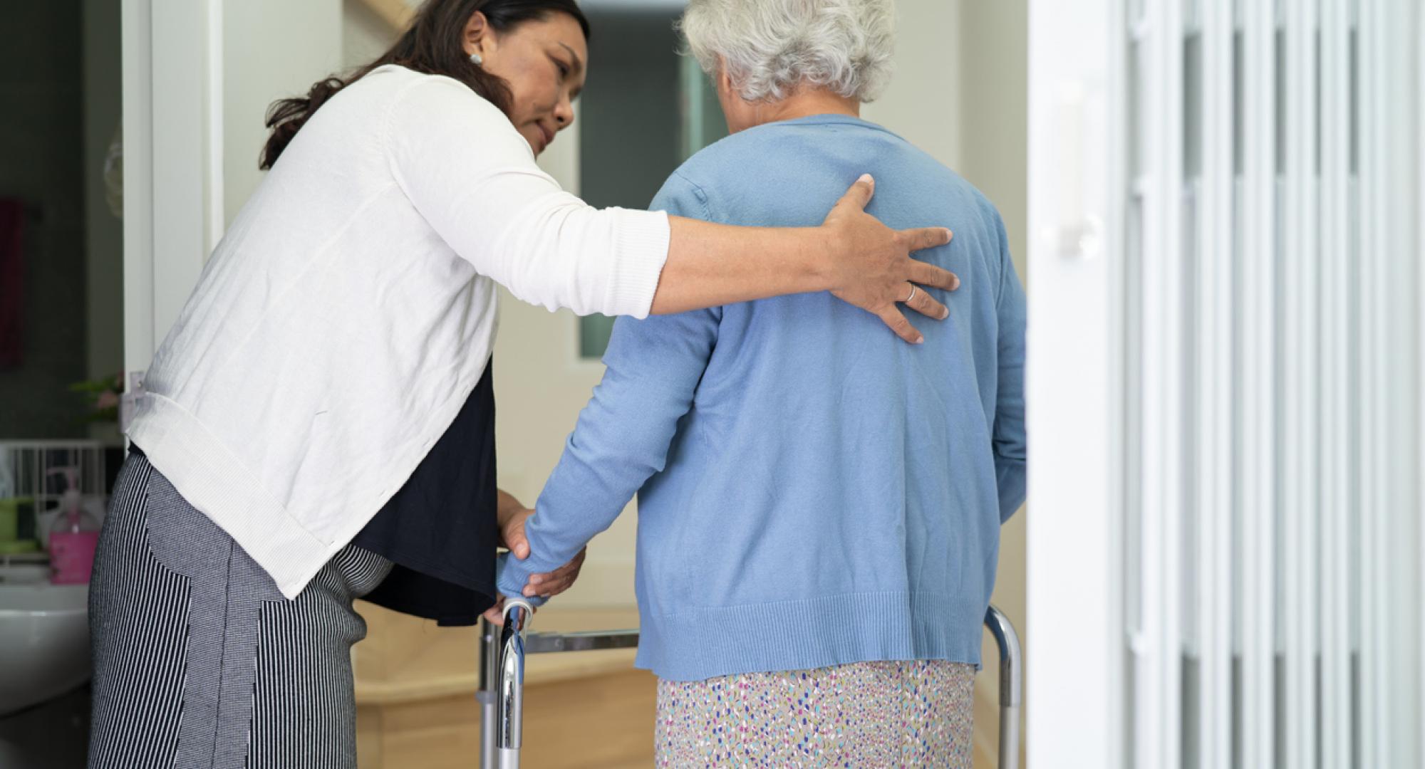 Caregiver helping an elderly woman